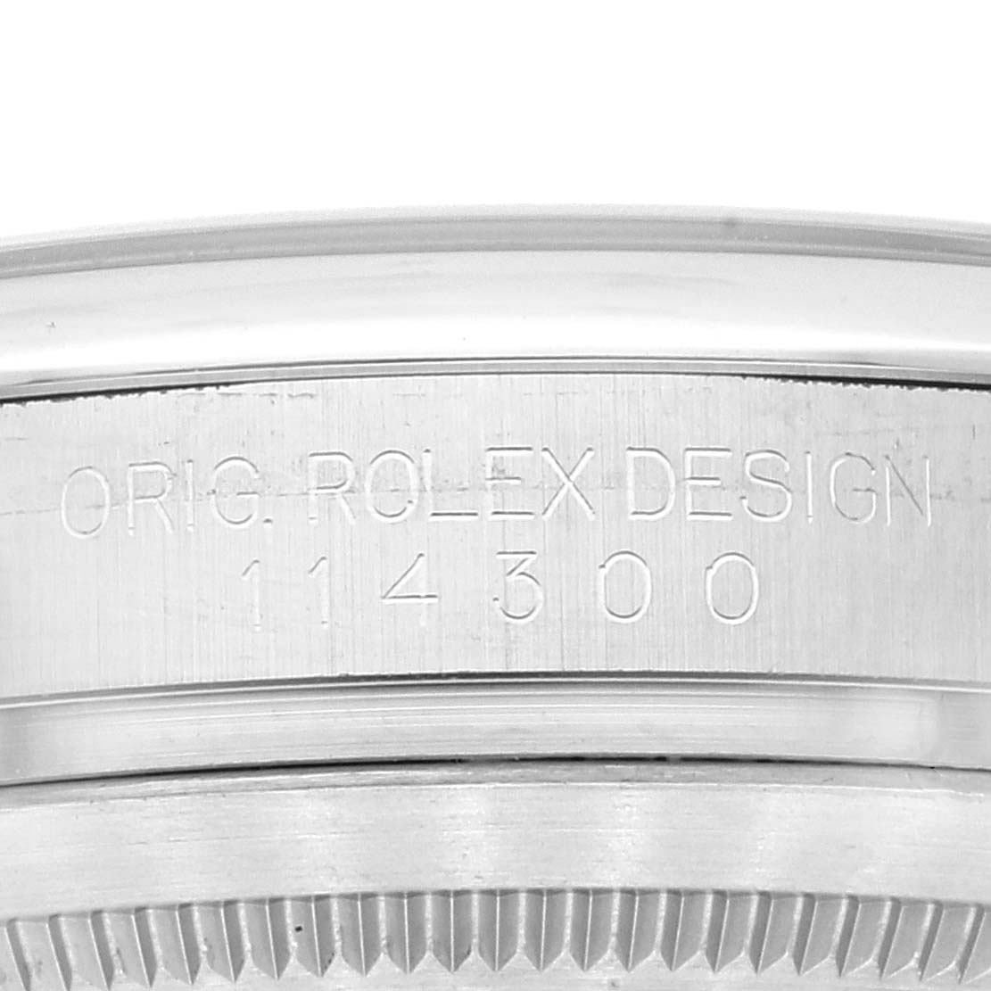 The image shows a close-up of the side of a Rolex Oyster Perpetual 114300 Men
s Stainless Steel Grey Dial 114300 Men
s Stainless Steel Grey Dial watch case, highlighting the engraved design number 114300.