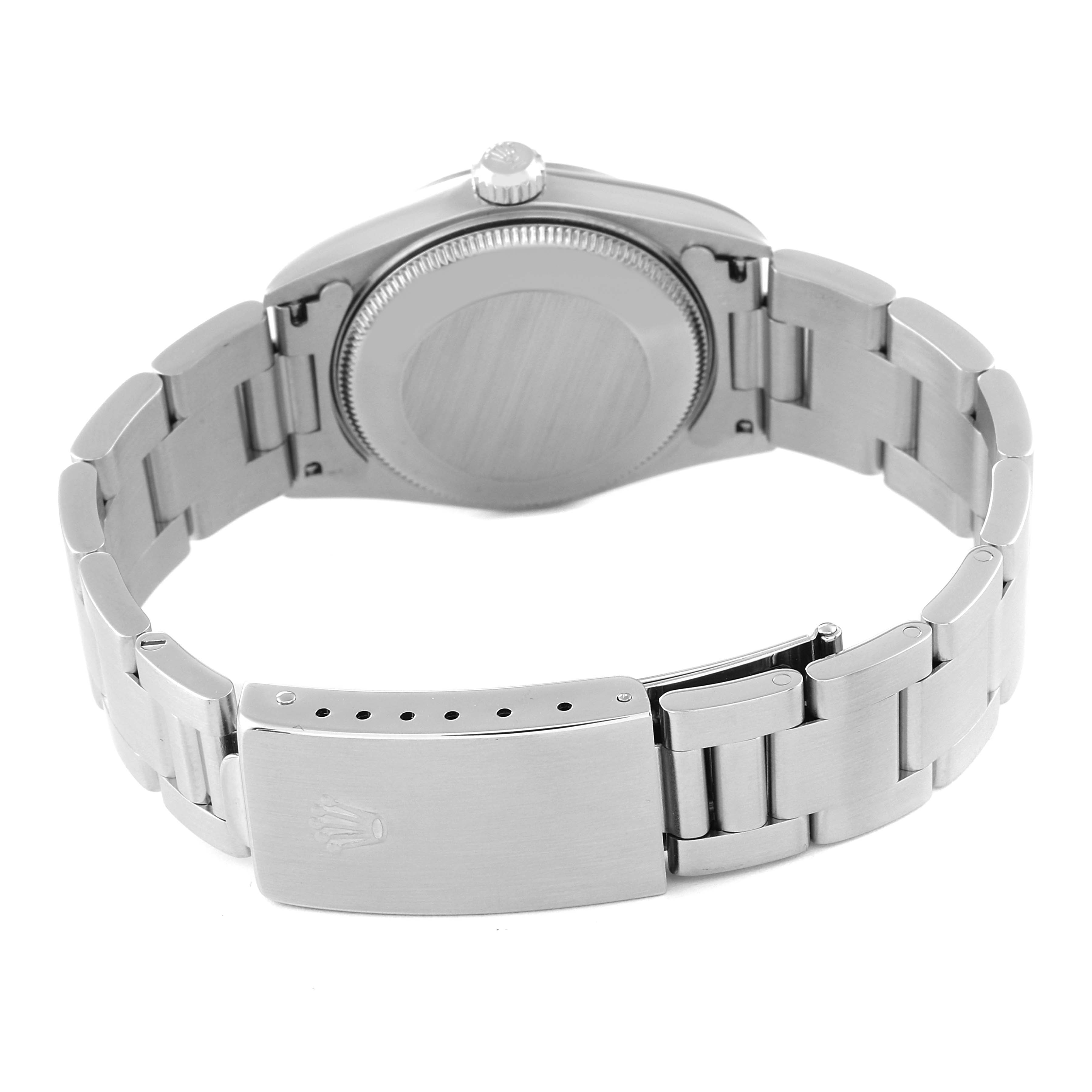 The image shows a rear view of a Mid-Size Rolex watch, highlighting the case back and stainless steel bracelet with clasp.