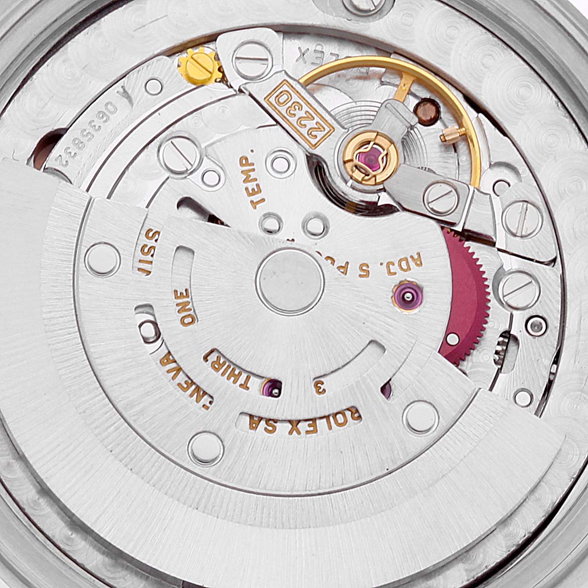 The image shows a close-up view of the intricate internal movement mechanism of the Mid-Size Rolex watch.