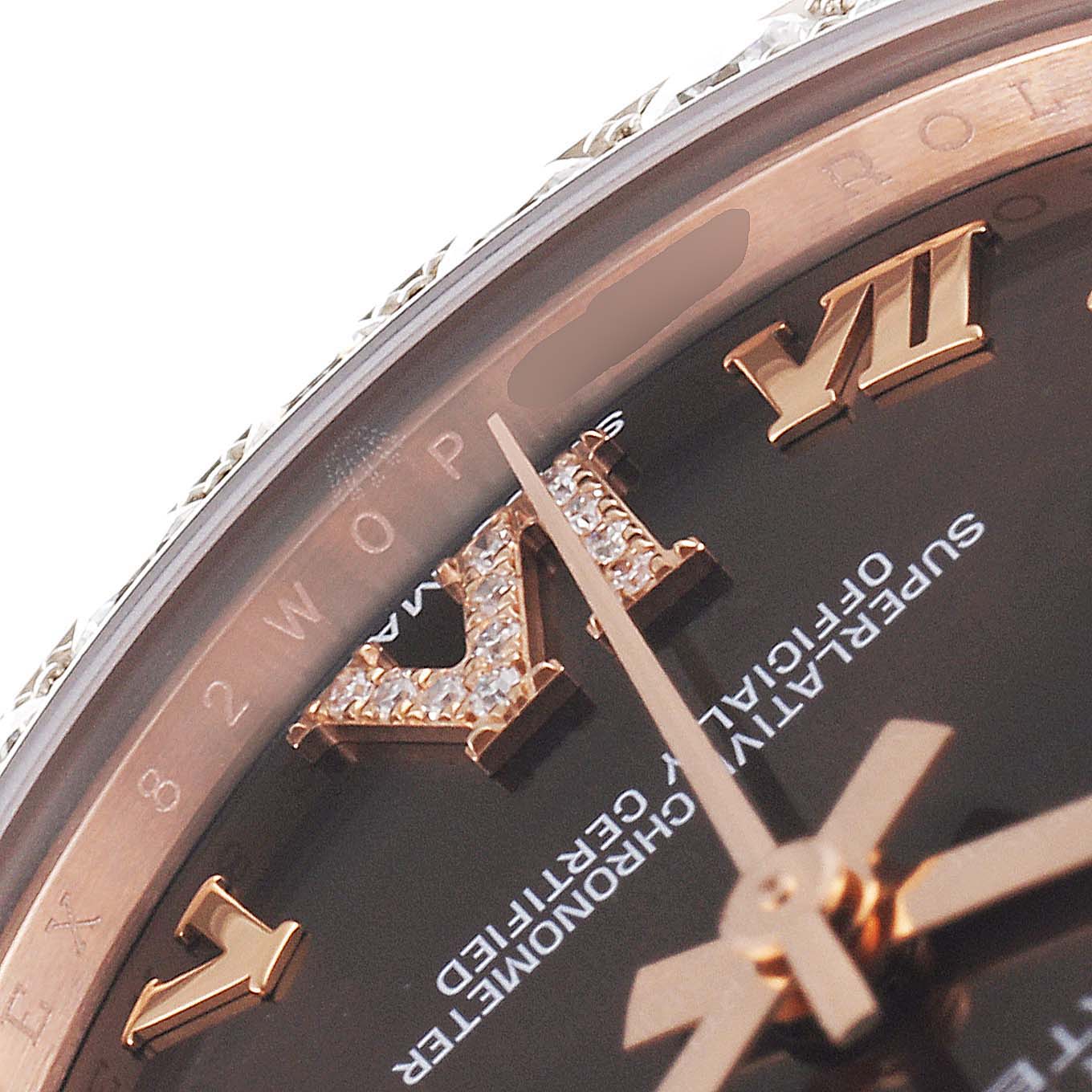 This close-up image shows the dial of the Rolex Pearlmaster 81285 Women's Rose Gold Brown Dial 81285 Women's Rose Gold Brown Dial watch, focusing on the Roman numerals and part of the bezel.
