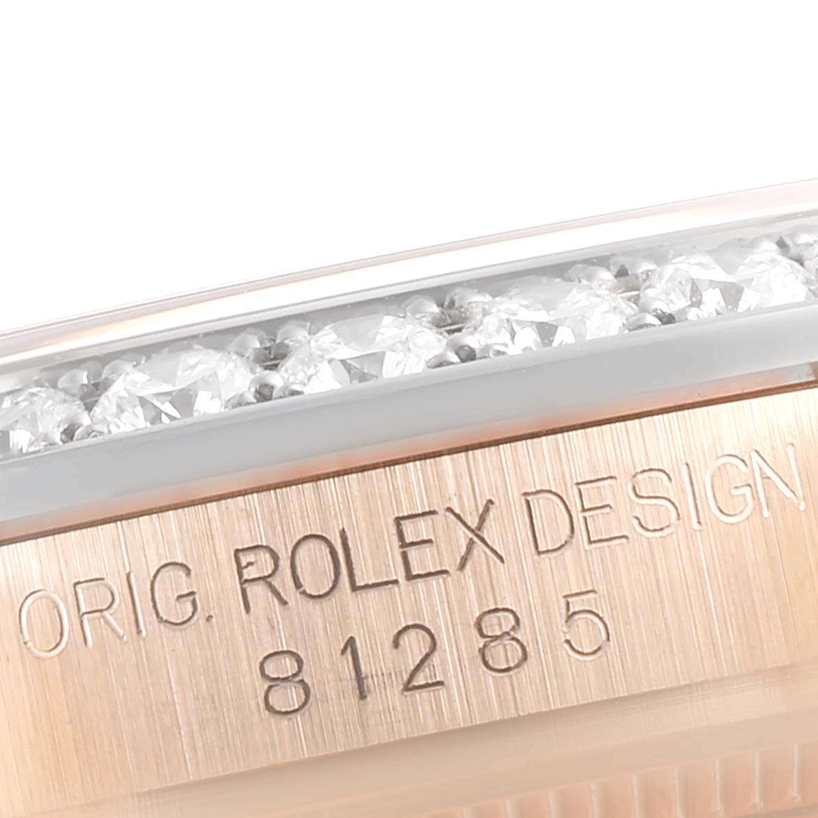 The image shows a close-up of the bezel and engraved reference number on a Rolex Pearlmaster 81285 Women's Rose Gold Brown Dial 81285 Women's Rose Gold Brown Dial watch.