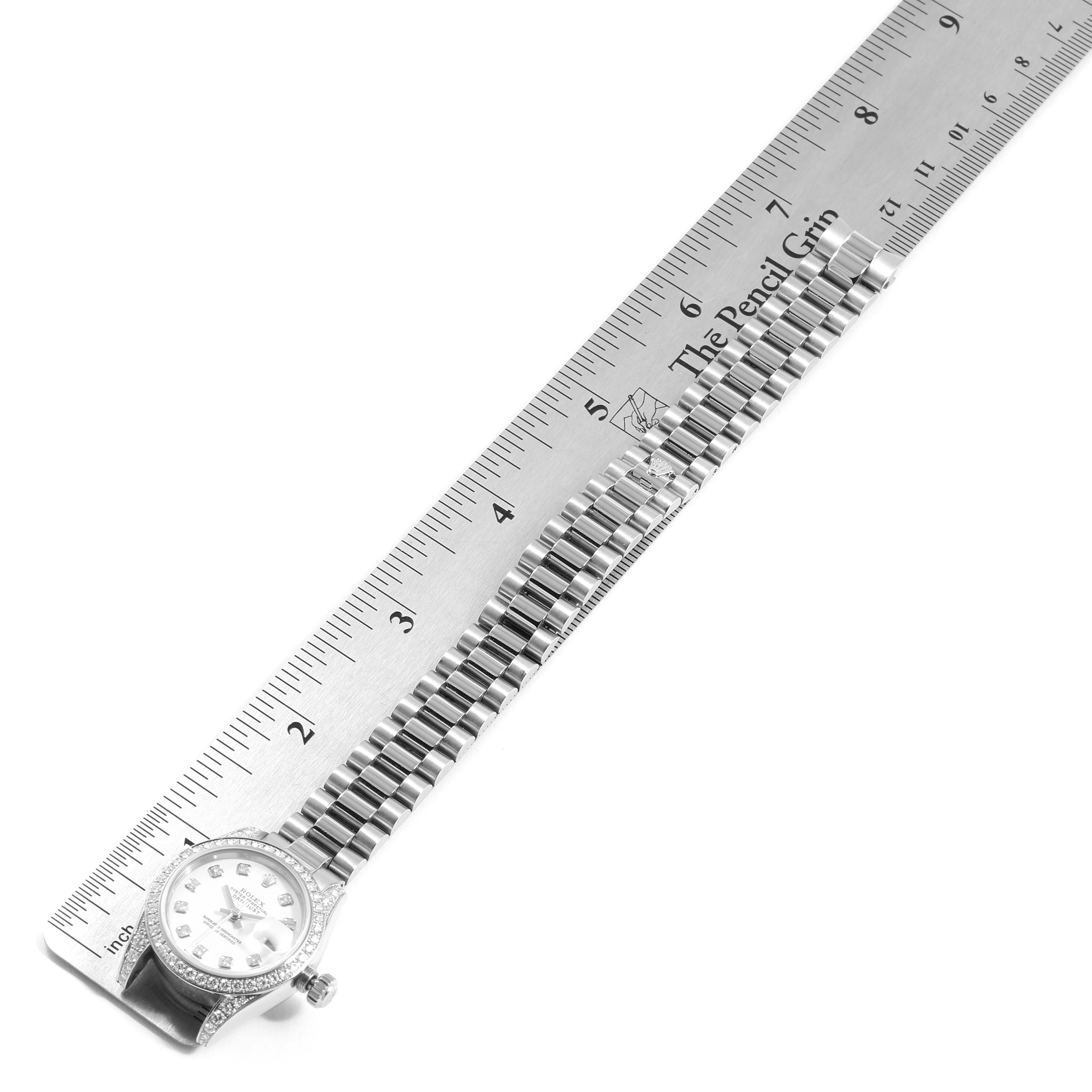 The image shows the side angle of the Rolex President 179159 Women's White Gold White Dial 179159 Women's White Gold White Dial model watch, including the face and the full bracelet, next to a ruler.