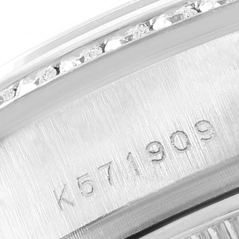Close-up of the bezel and inner ring of a Rolex President 179159 Women's White Gold White Dial 179159 Women's White Gold White Dial model watch, showing diamonds and a serial number.