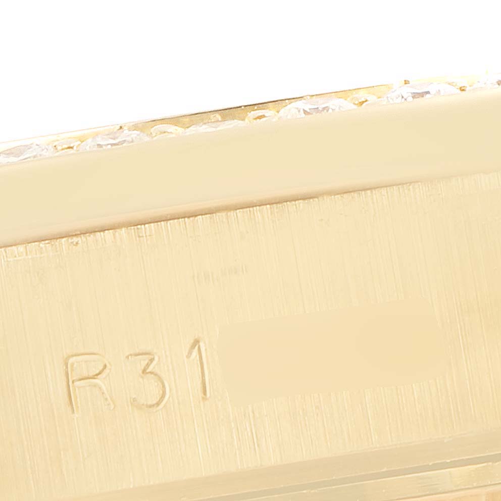 The image shows a close-up angle of the side of the case of a Rolex President 69138 Women's Yellow Gold Champagne Dial 69138 Women's Yellow Gold Champagne Dial model with visible engravings.