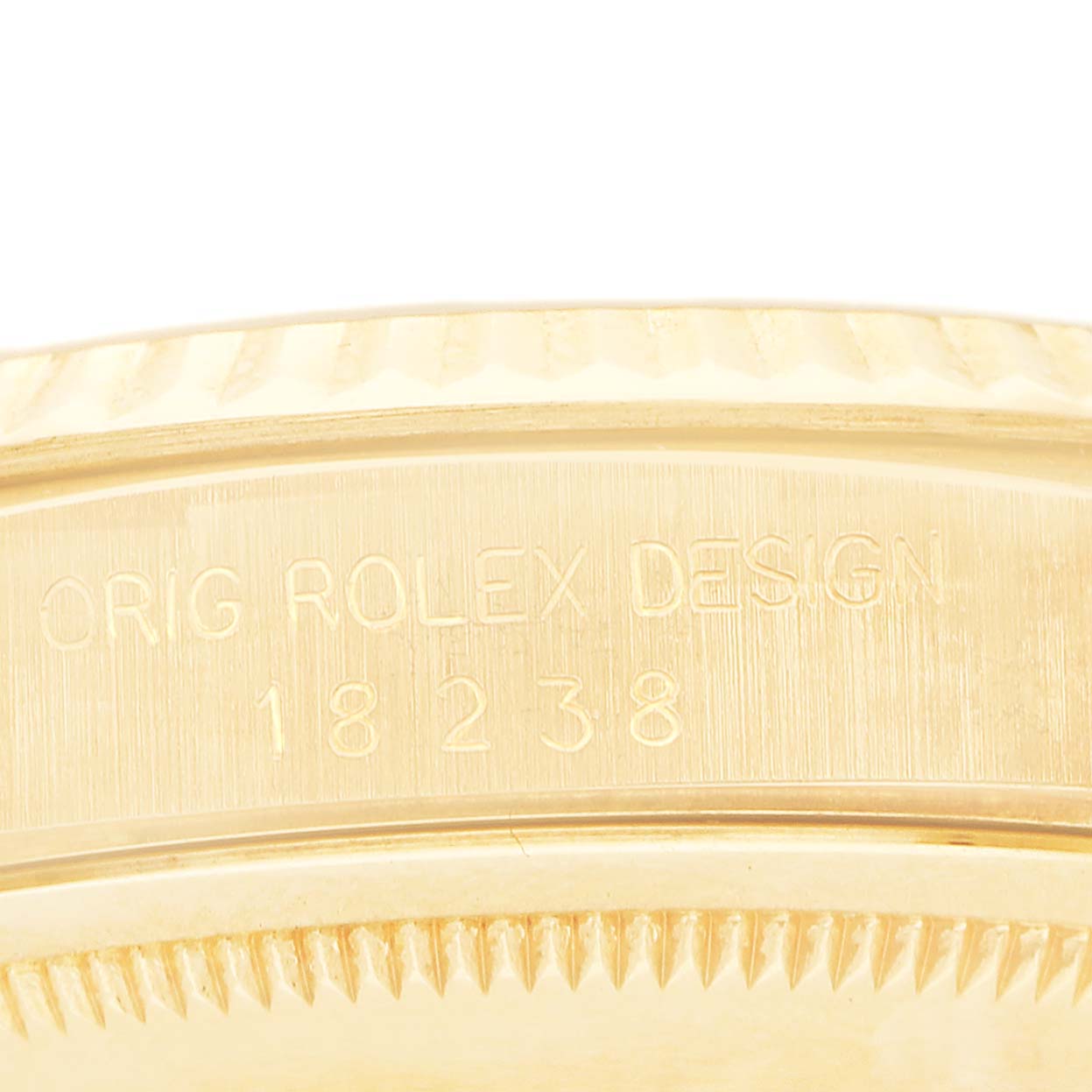 The image shows the side engraving on the case of a Rolex President 18238 Men's Yellow Gold White Dial model, displaying "ORIG ROLEX DESIGN" and the model number.