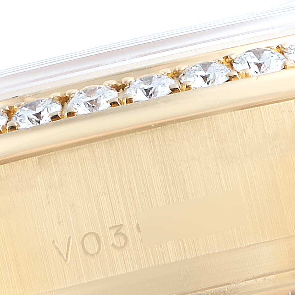 This image shows a close-up angle of the bezel and part of the case of a Rolex President 179138 Women's Yellow Gold Champagne Dial 179138 Women's Yellow Gold Champagne Dial watch, highlighting the diamonds.