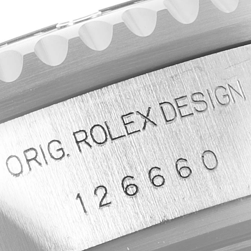 This image shows a close-up of the engraving on the side of the bezel and case of a Rolex Sea-Dweller 126660 Men's Stainless Steel Blue Dial 126660 Men's Stainless Steel Blue Dial watch.
