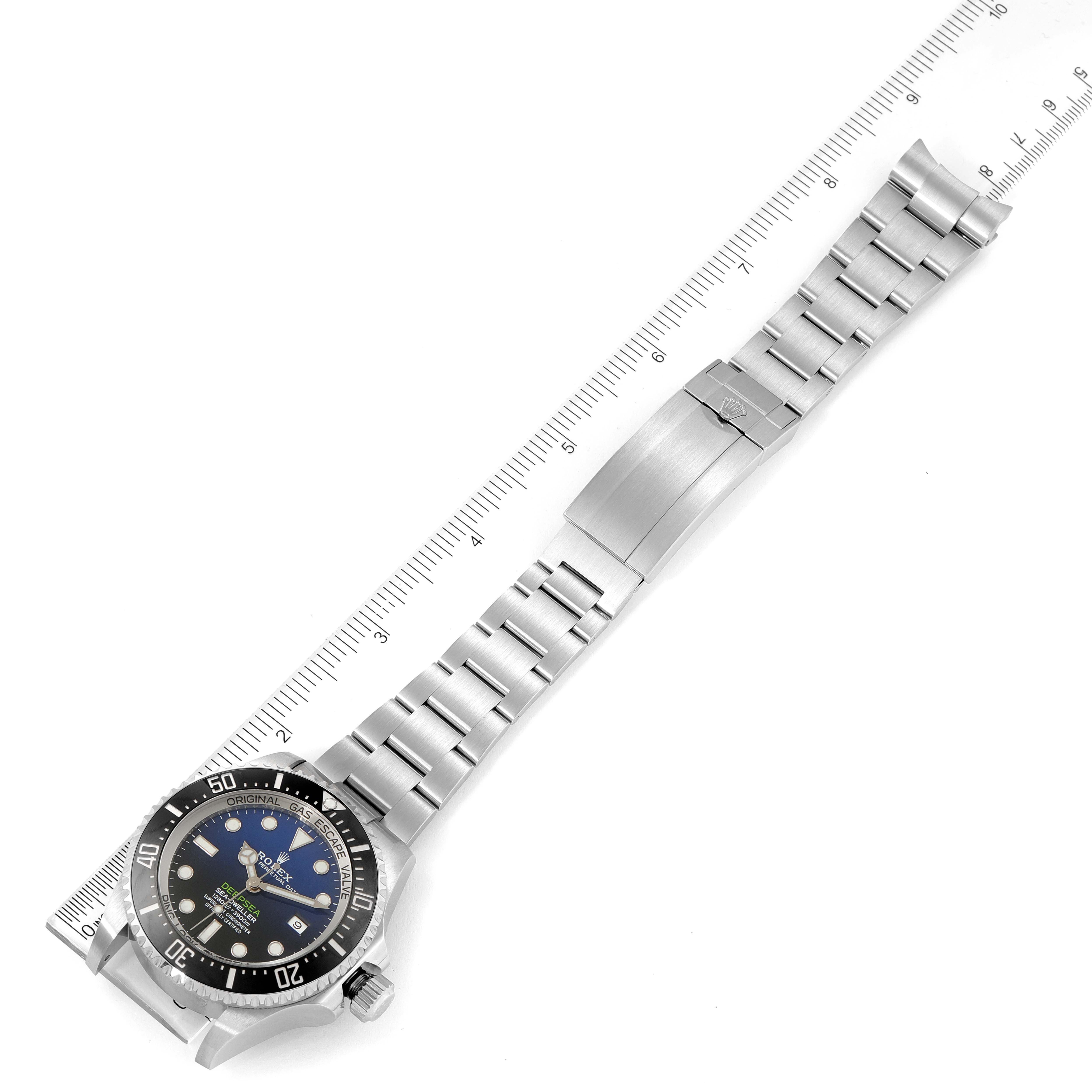The image shows a top-down view of a Rolex Sea-Dweller 126660 Men
s Stainless Steel Blue Dial 126660 Men
s Stainless Steel Blue Dial watch with a ruler for scale, displaying the watch face and bracelet.