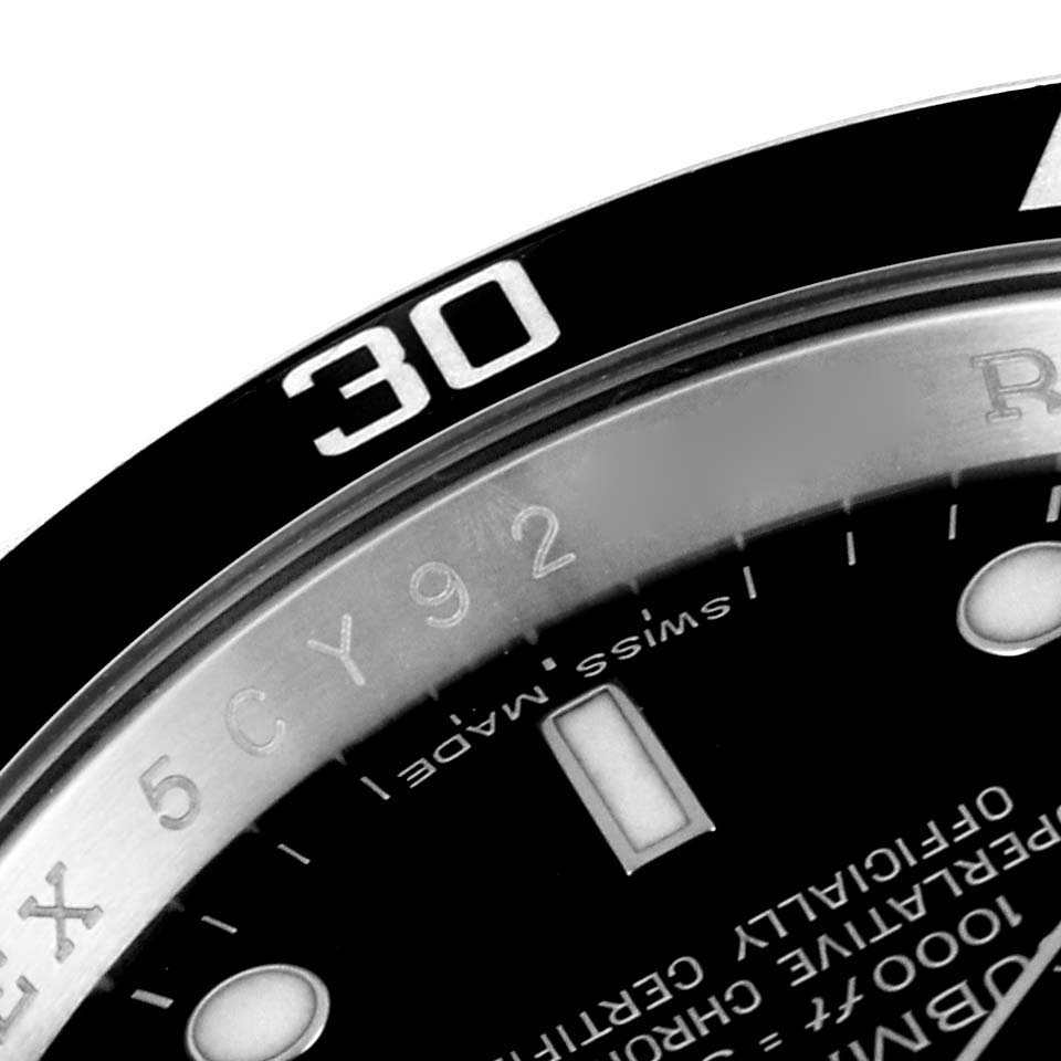 The image shows a close-up of the bezel and a portion of the dial of a Rolex Submariner 16610 Men
s Stainless Steel Black Dial 16610 Men
s Stainless Steel Black Dial watch.