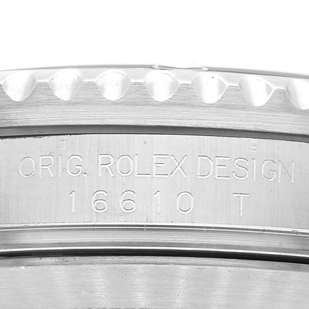 The image shows a close-up shot of the Rolex Submariner 16610 Men
s Stainless Steel Black Dial 16610 Men
s Stainless Steel Black Dial
s case, displaying the model number 16610 etched on it.