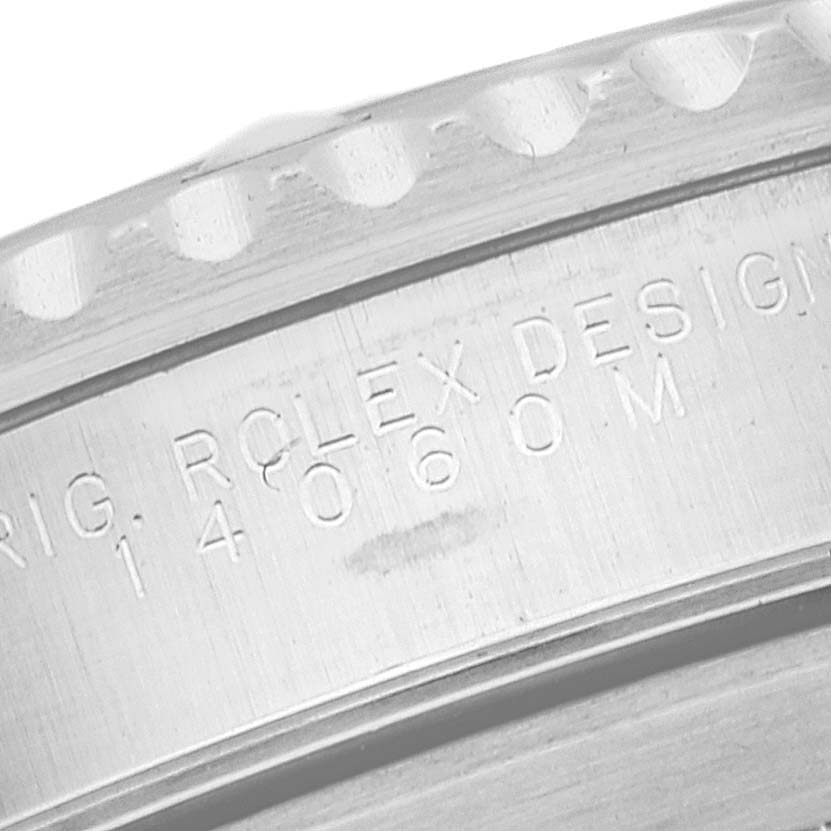 This close-up image shows the engraved text on the side of a Rolex Submariner 14060M Men
s Stainless Steel Black Dial 14060M Men
s Stainless Steel Black Dial watch case.