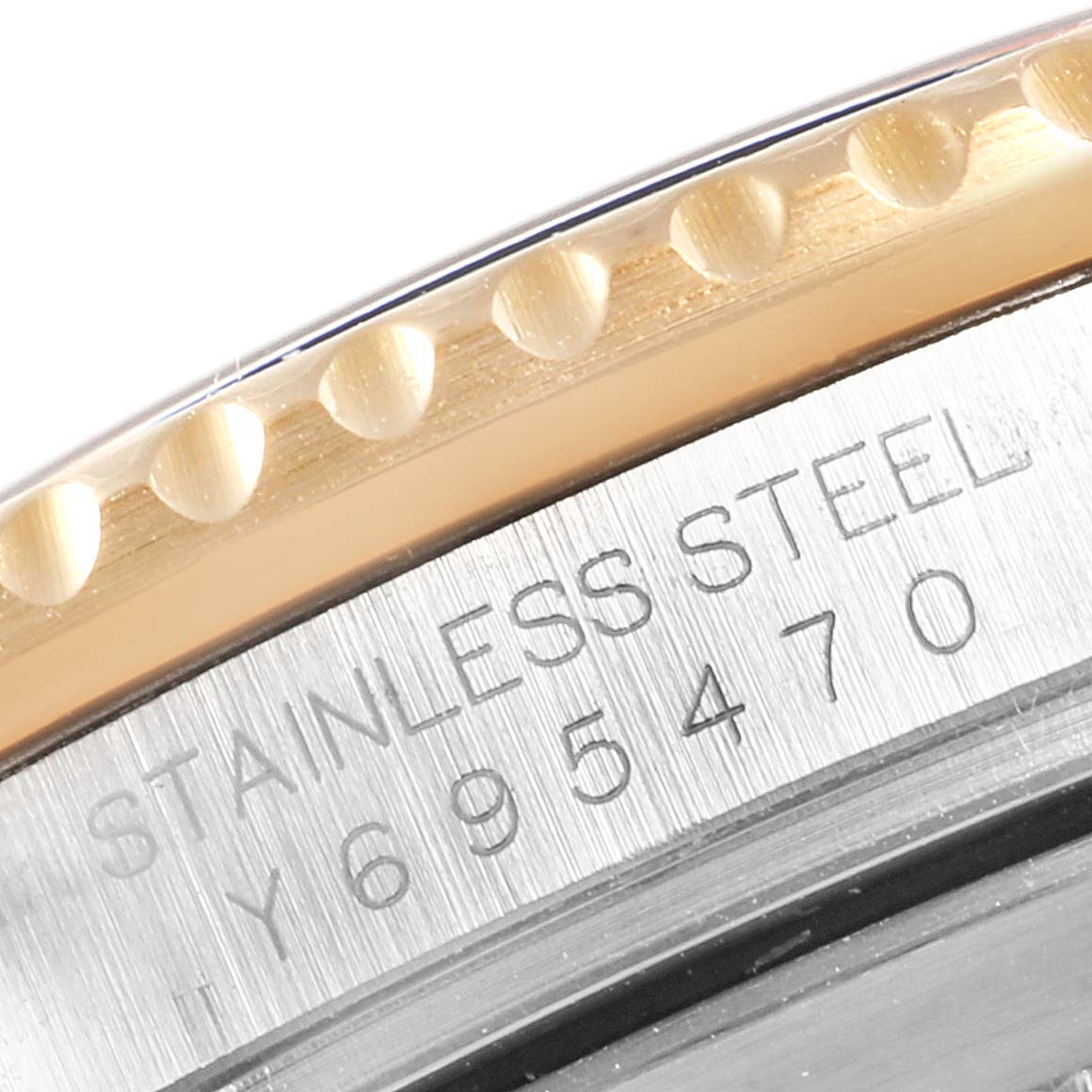 This image shows a close-up of the serial number engraving on the bezel and case side of a Rolex Submariner 16613 Men
s Steel and Gold (two tone) Champagne Dial 16613 Men
s Steel and Gold (two tone) Champagne Dial watch.
