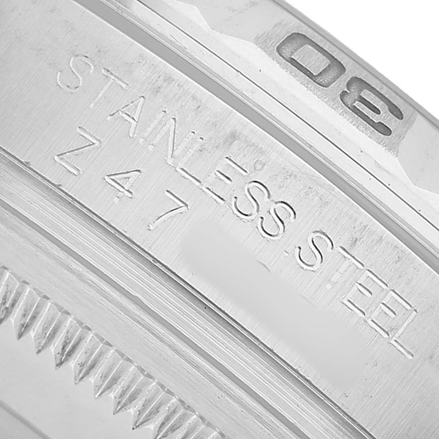 The close-up image shows the stainless steel bezel of a Rolex Turn-o-Graph 116264 Men's Stainless Steel Black Dial watch with engraved markings.