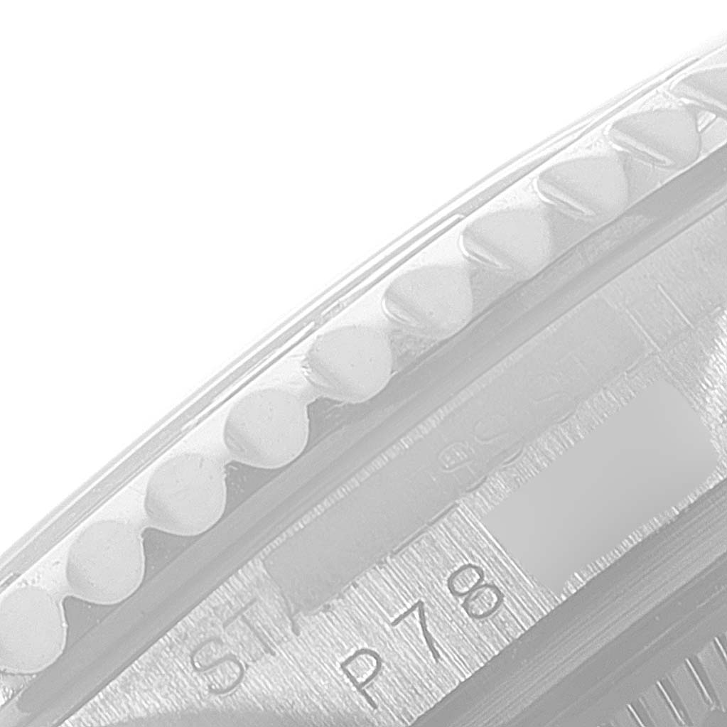 This image shows a close-up of the Rolex Yacht-Master 168622 Men's Stainless Steel Silver Dial 168622 Men's Stainless Steel Silver Dial watch bezel and part of the casing, viewed at an oblique angle.