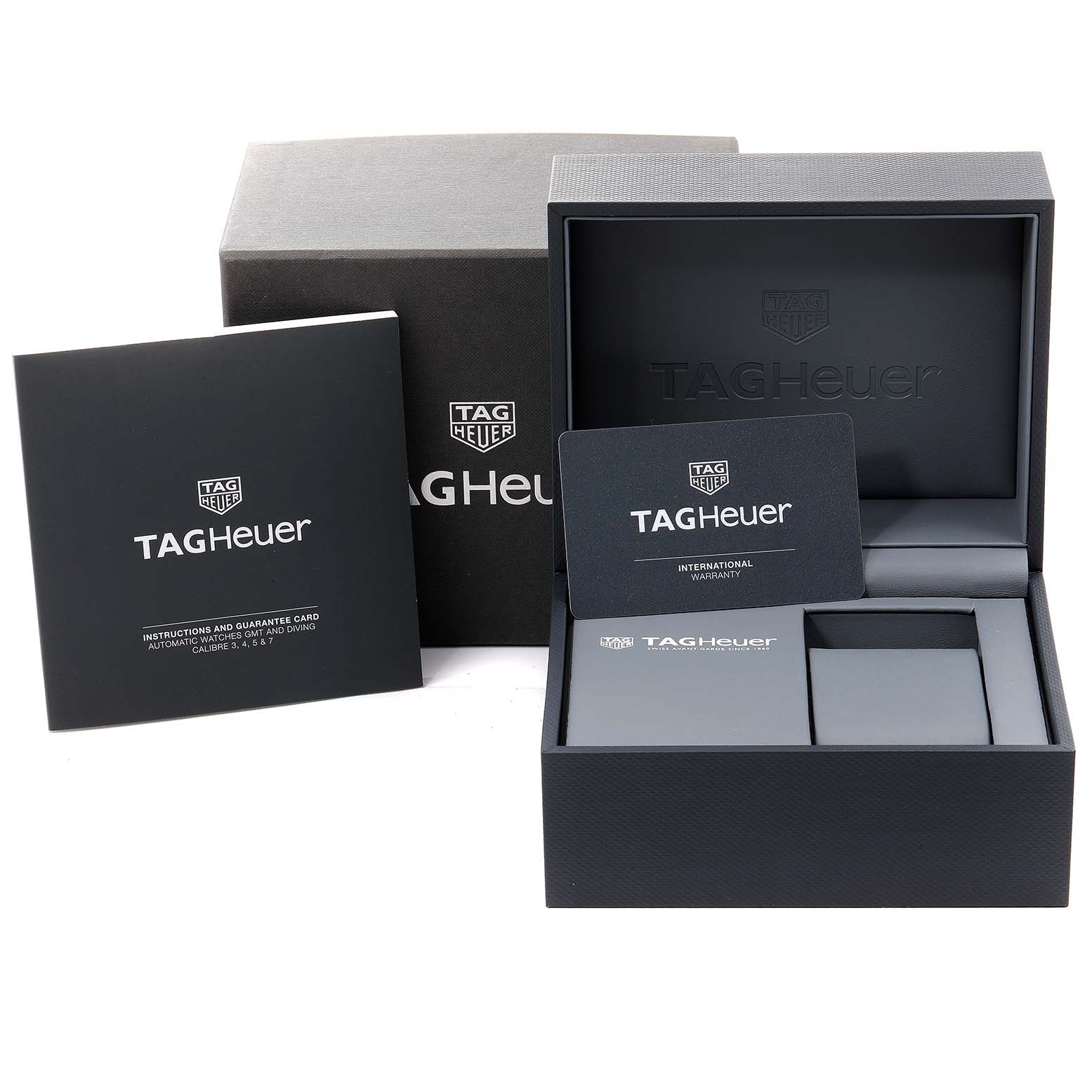 The image shows packaging and accessories for a Tag Heuer Formula 1 WAZ211A.BA0875 Men's Stainless Steel Black Dial WAZ211A.BA0875 Men's Stainless Steel Black Dial watch, including boxes, a warranty card, and an instruction manual.