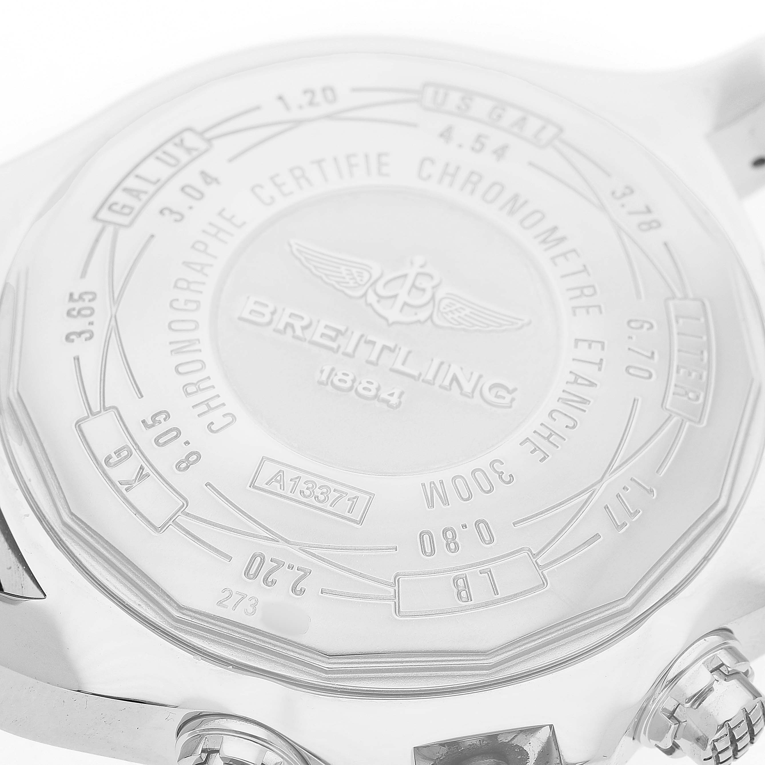 The image shows the case back of a Breitling Avenger A13371 Men's Stainless Steel White Dial watch, featuring engraved text and the brand's emblem.