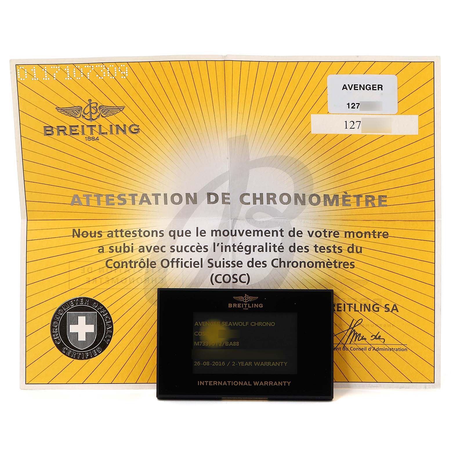 The image shows the warranty card and chronometer certificate for the Breitling Avenger M73390 Men
s Stainless Steel Black Dial M73390 Men
s Stainless Steel Black Dial model.