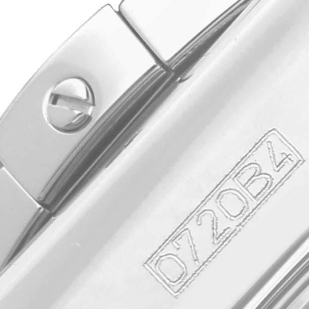 The image shows a close-up of a part of the Breitling Chronomat AB01152A/BH20 Men's Stainless Steel Mother of Pearl Dial AB01152A/BH20 Men's Stainless Steel Mother of Pearl Dial watch, featuring a screw and engraved lettering.