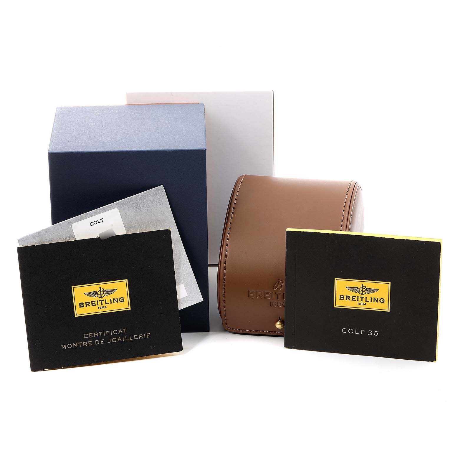 The image shows packaging and paperwork for a Breitling A74389 Women
s Stainless Steel Mother of Pearl Dial A74389 Women
s Stainless Steel Mother of Pearl Dial Colt 36 MOP Diamond Dial Steel Ladies Watch A74389 Unworn model.