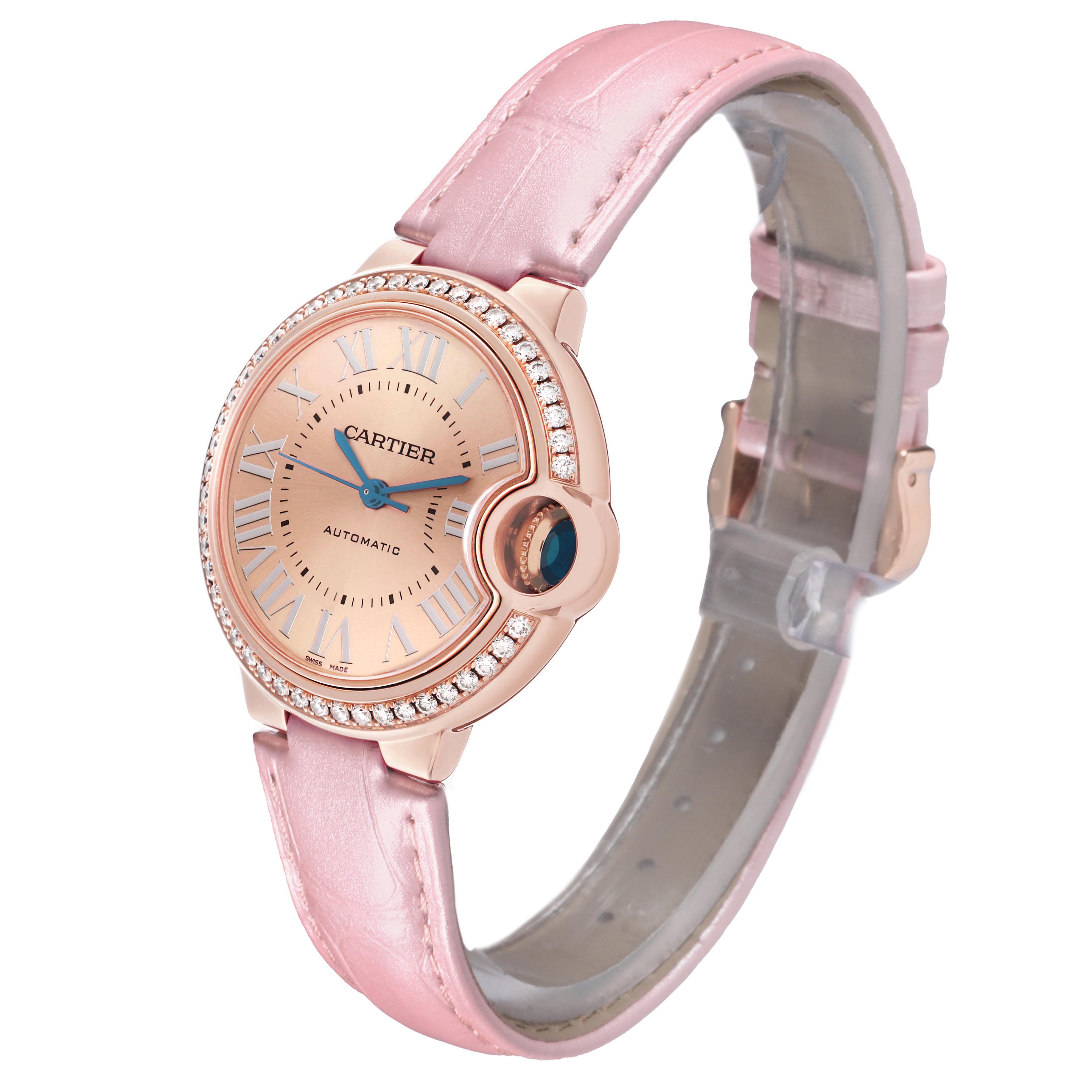 The Cartier Ballon Bleu WJBB0076 Women's Rose Gold Pink Dial watch is shown at a slight angle, highlighting the face, bezel, crown, and strap.