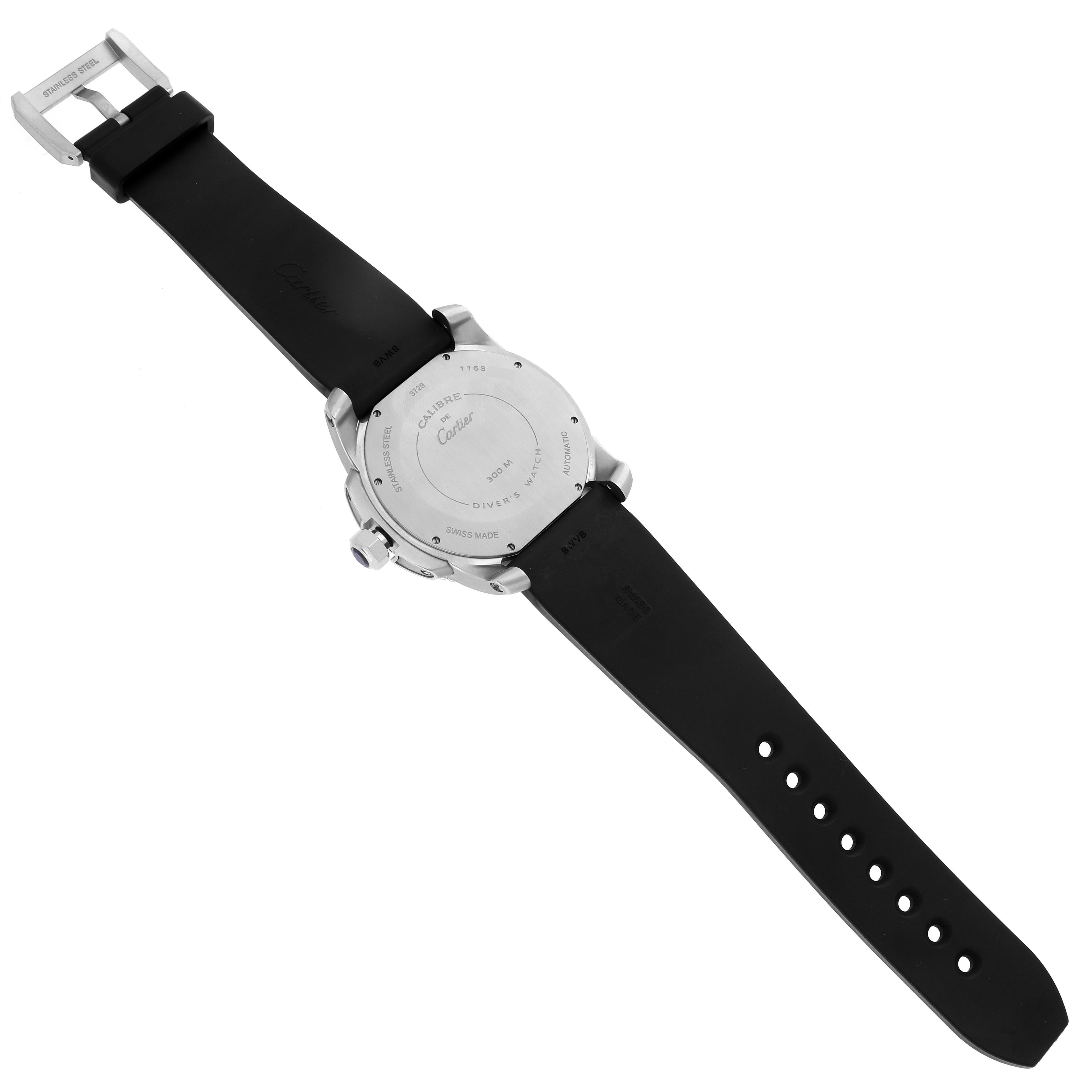 The image shows the back of the Calibre de Cartier watch by Cartier, focusing on the case back and the rubber strap with a buckle.