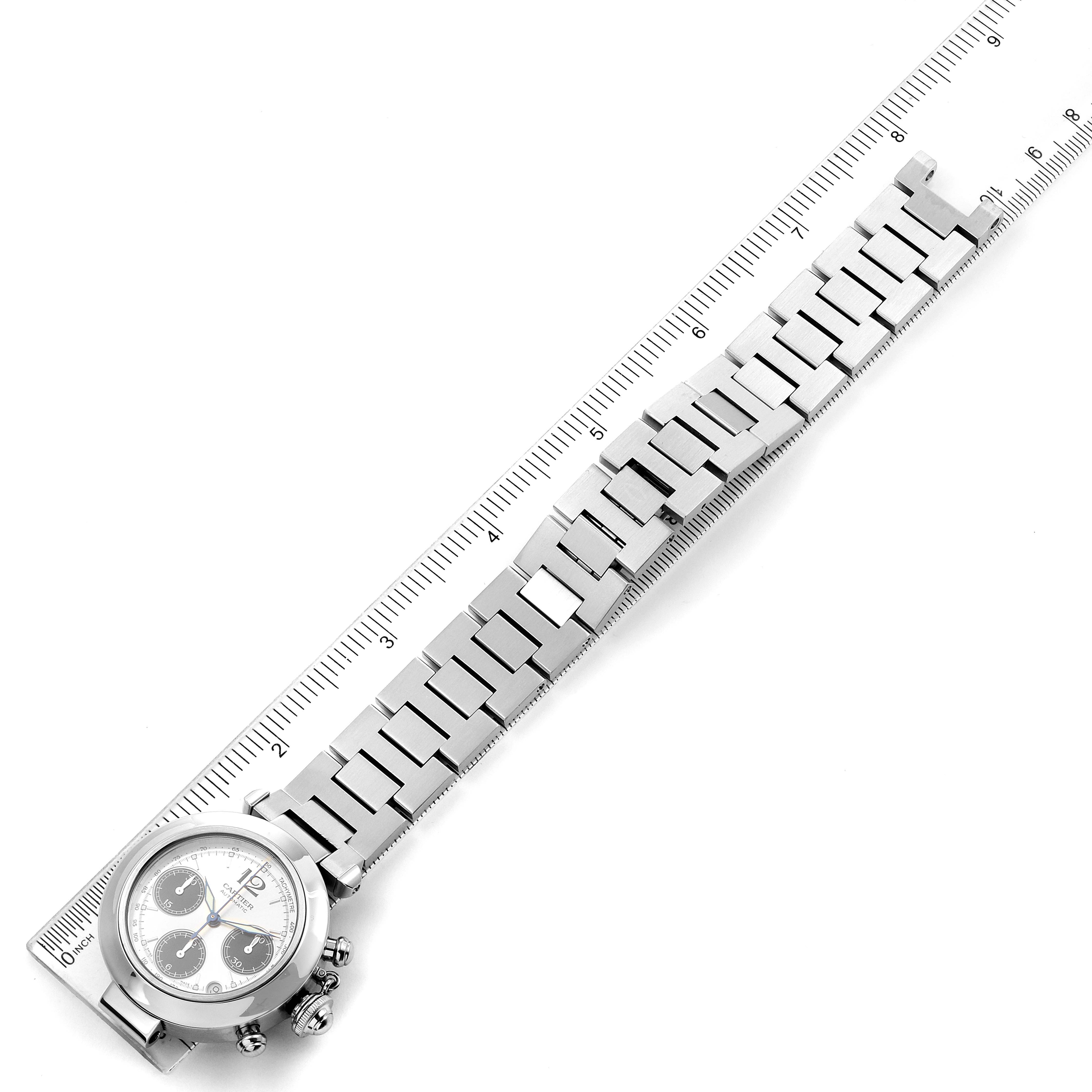 The image shows a side angle view of the Cartier Pasha W31048M7 Men's Stainless Steel Silver Dial W31048M7 Men's Stainless Steel Silver Dial watch with its band laid out beside a ruler for measurement.