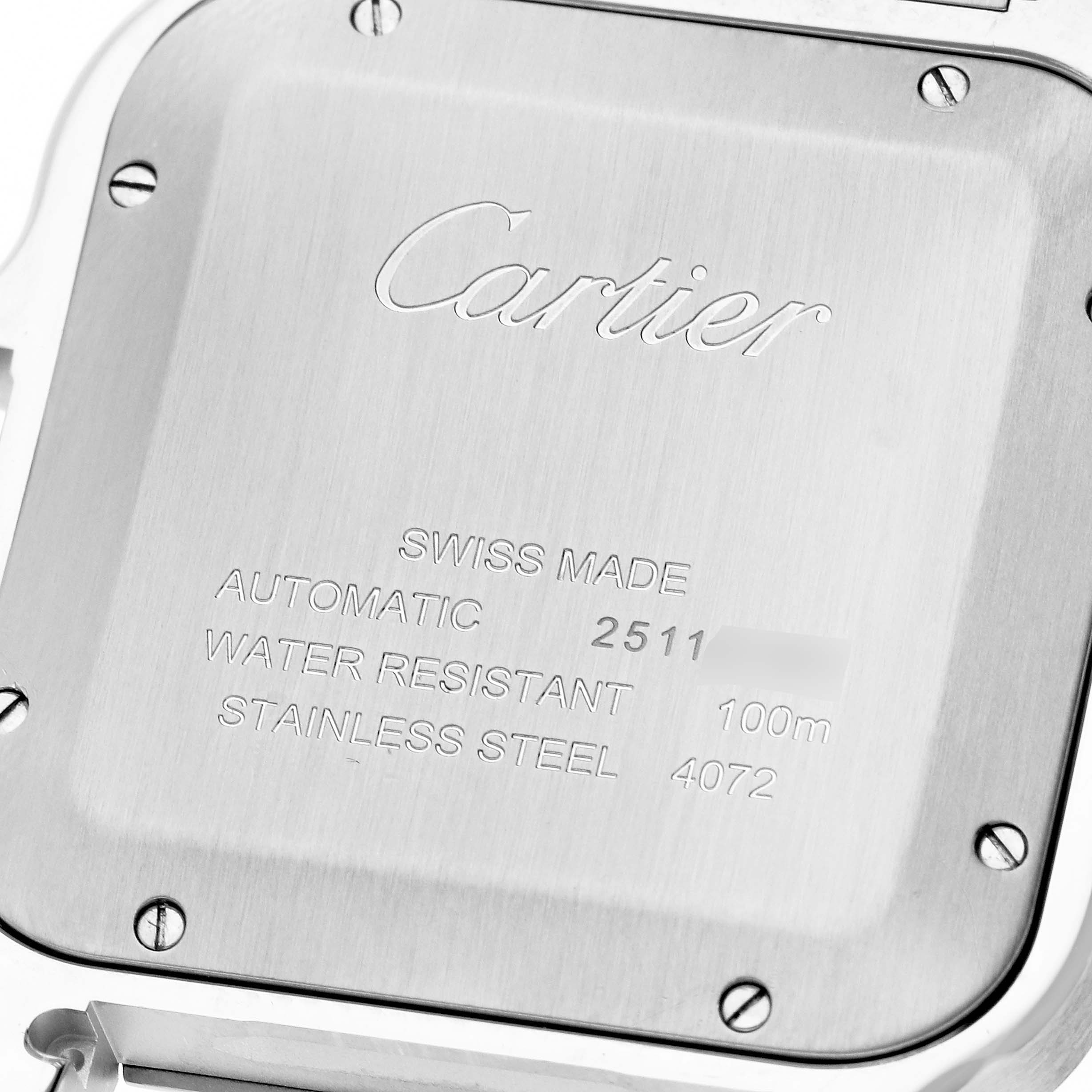 The image shows the back case of a Cartier Santos WSSA0030 Men's Stainless Steel Blue Dial WSSA0030 Men's Stainless Steel Blue Dial watch, featuring engraved details about the model, water resistance, and material.