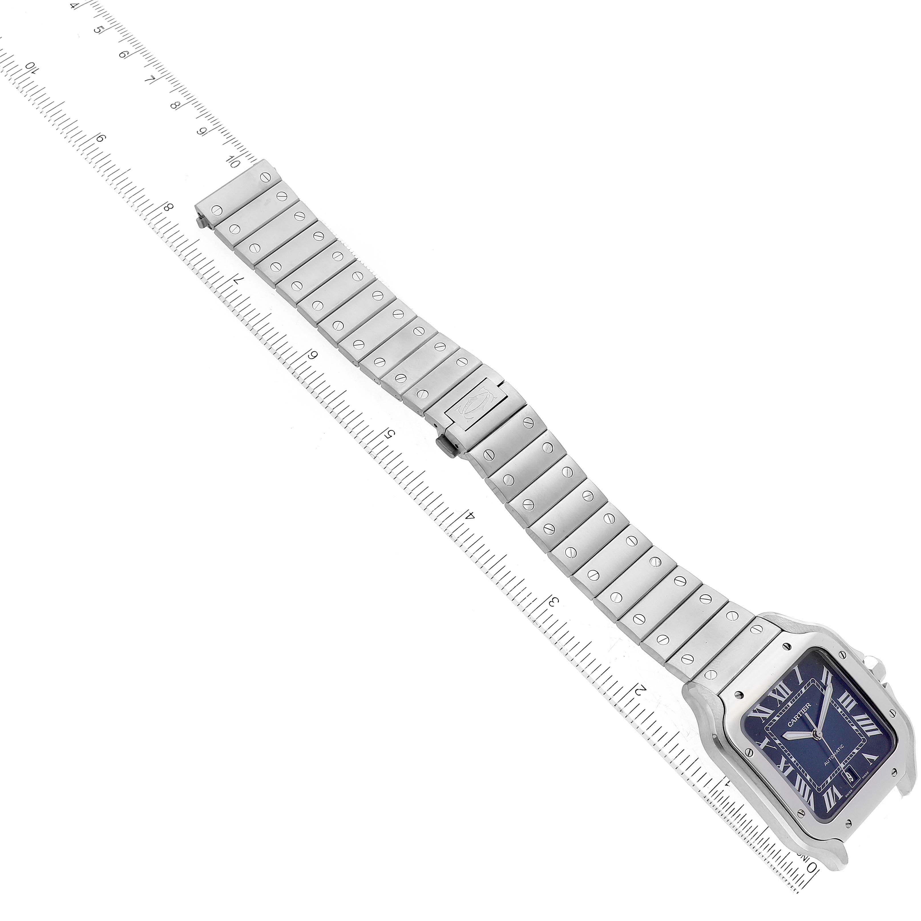 This image shows a top-down view of a Cartier Santos WSSA0030 Men's Stainless Steel Blue Dial WSSA0030 Men's Stainless Steel Blue Dial watch with a ruler beside its metal strap.