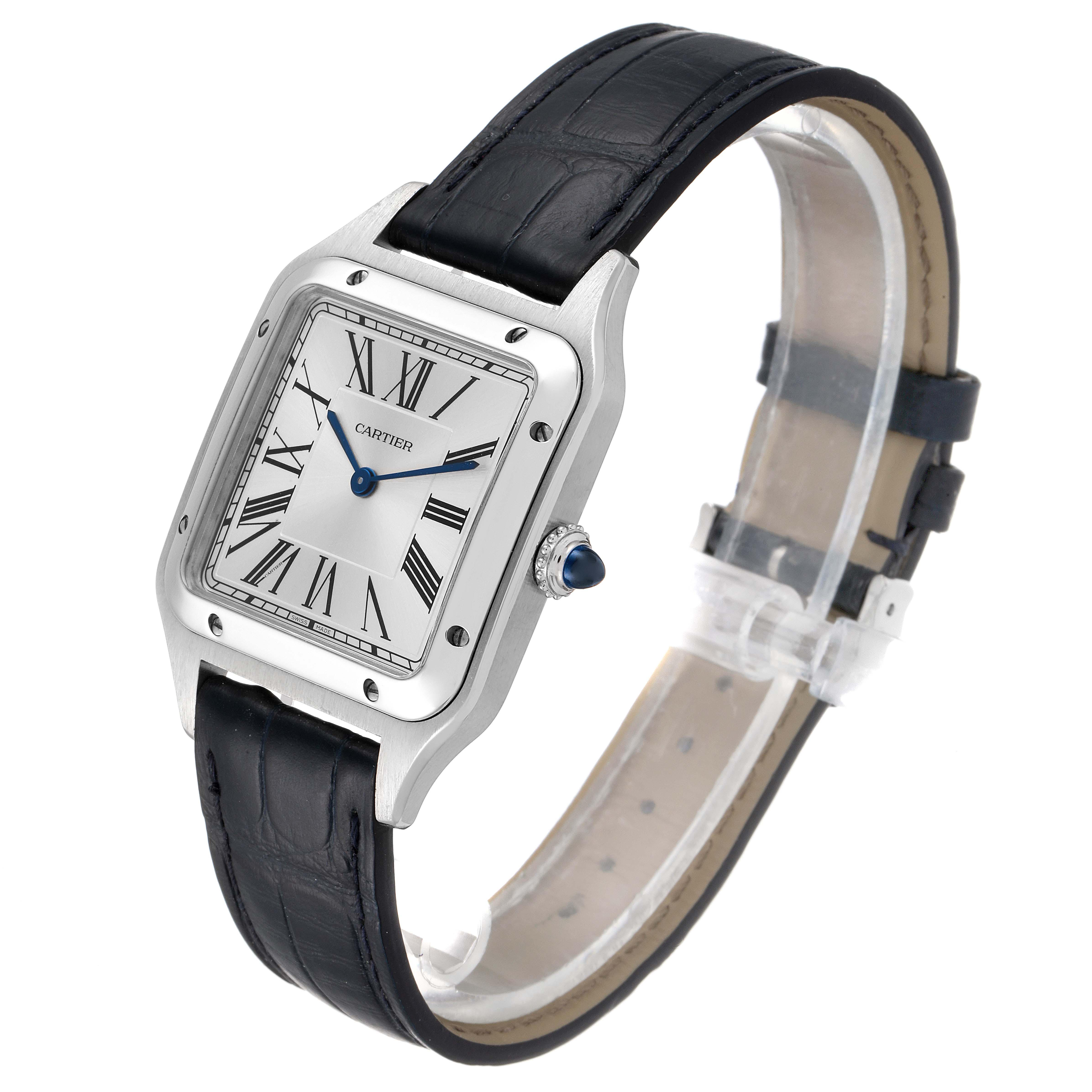 The image shows a side angle of the Santos Dumont model by Cartier, highlighting its silver square face, black leather strap, and blue hands.