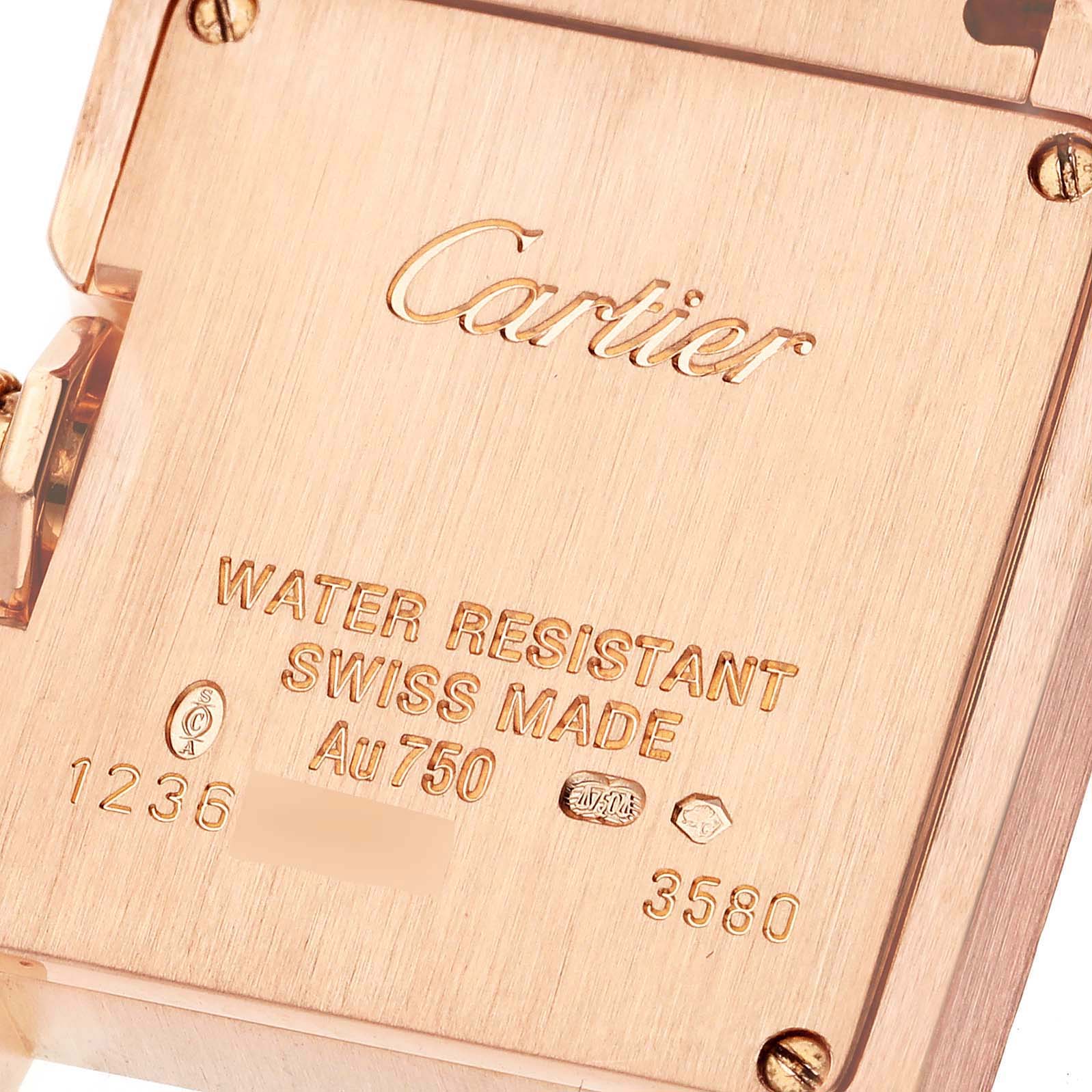 This image shows the back side of a Cartier Tank Anglaise WT100002 Women
s Rose Gold Silver Dial WT100002 Women
s Rose Gold Silver Dial watch, detailing the engravings and markings.