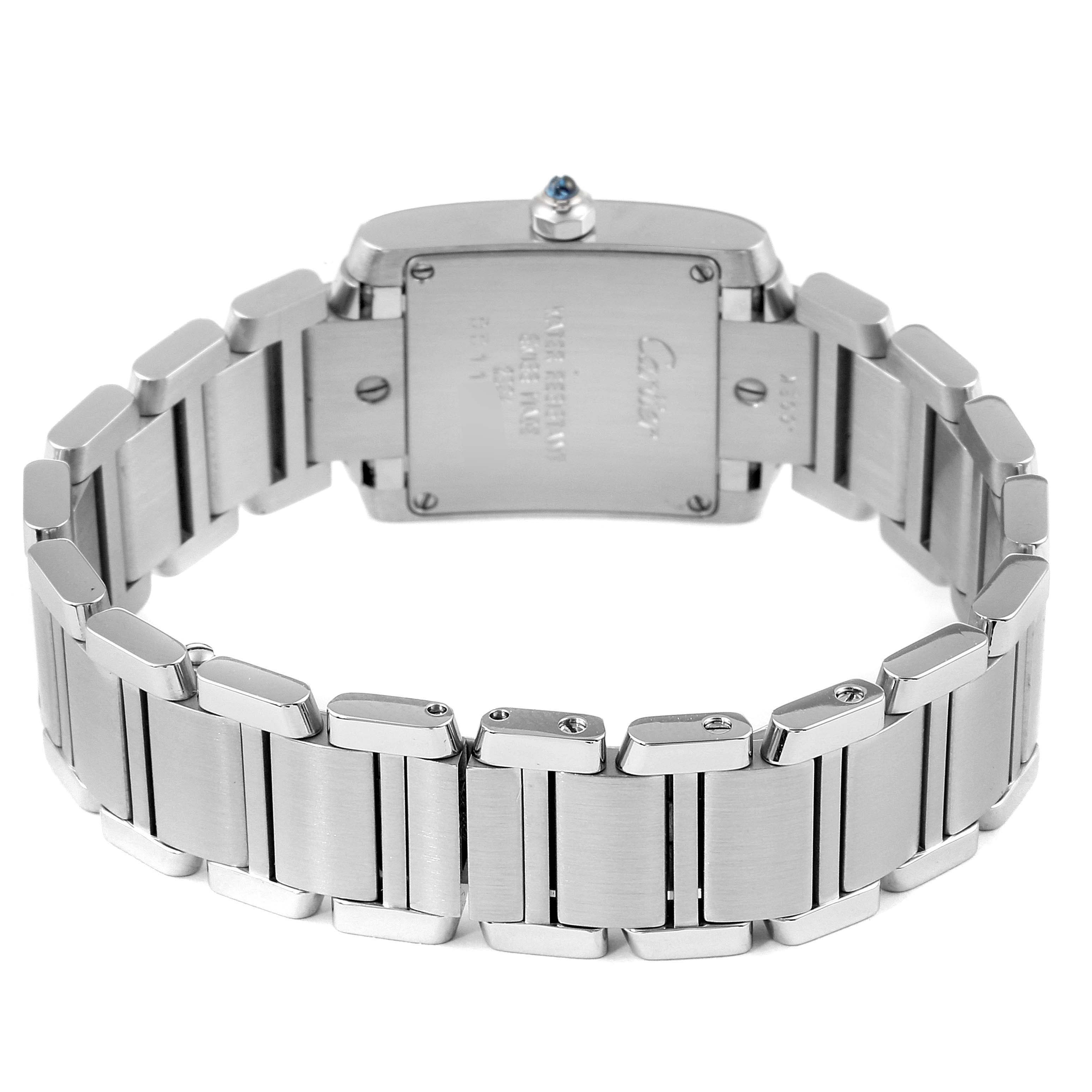 The image shows the back view of the Tank Francaise watch by Cartier, highlighting its stainless steel bracelet and the watch case.