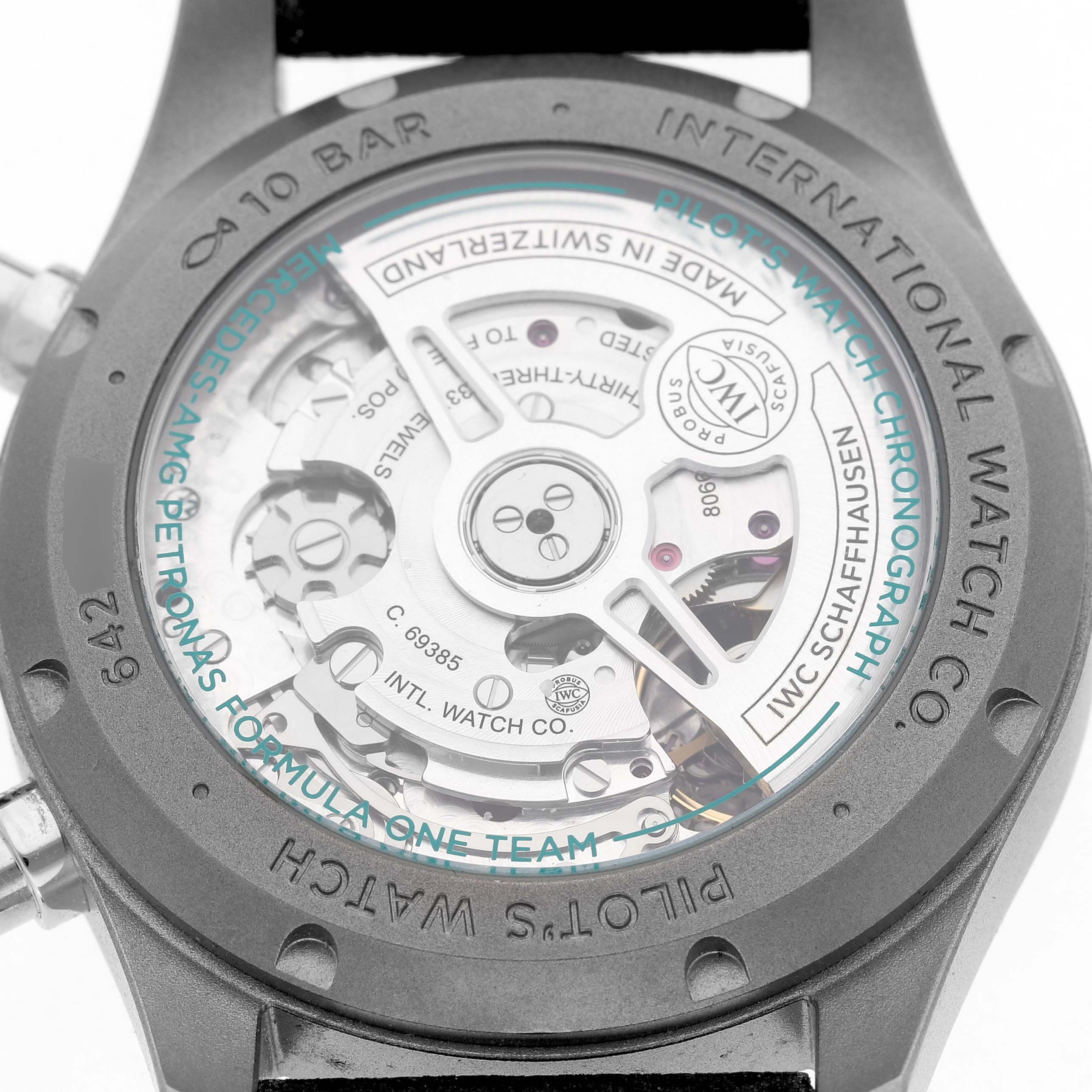 The image shows the back of the IWC Pilot IW370607 Men's Titanium Black Dial's Watch, revealing the intricate movement and branding details.