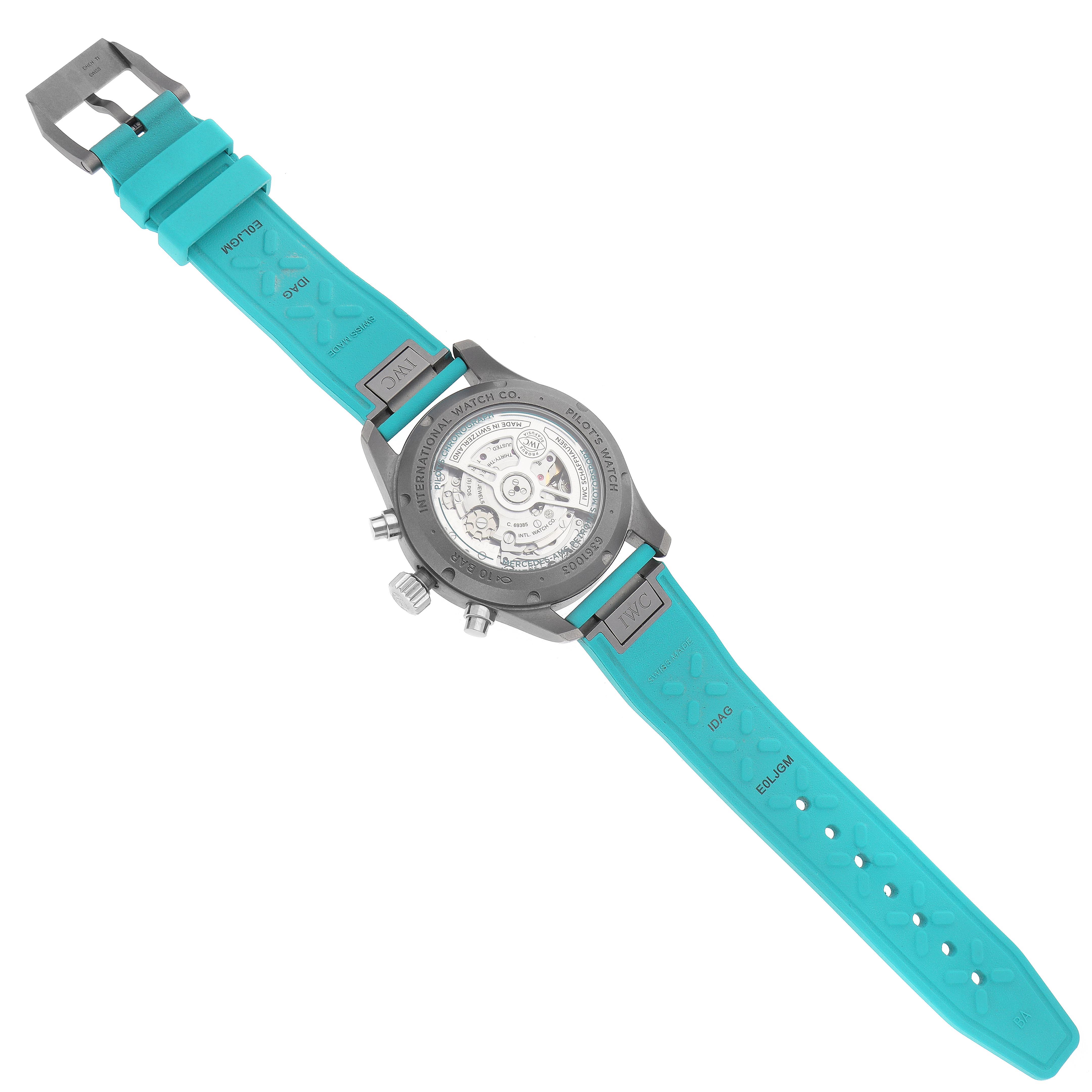 The IWC Pilot IW388108 Men's Titanium Black Dial IW388108 Men's Titanium Black Dial watch is shown from the back, displaying the case back, movement, and turquoise strap.