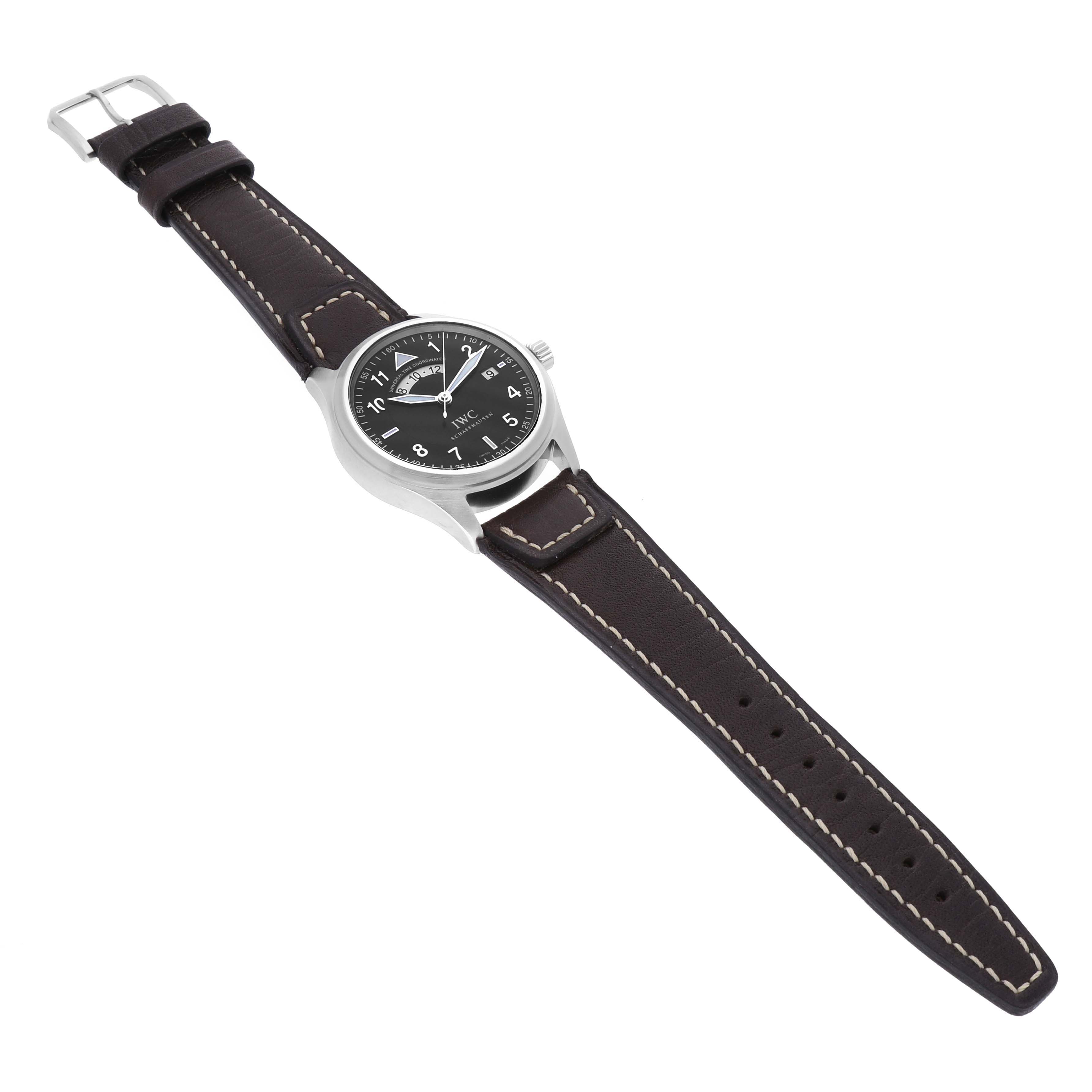 The IWC Pilot IW325105 Men's Stainless Steel Black Dial IW325105 Men's Stainless Steel Black Dial watch is shown from a top-down angle, displaying its black dial and brown leather strap with white stitching.