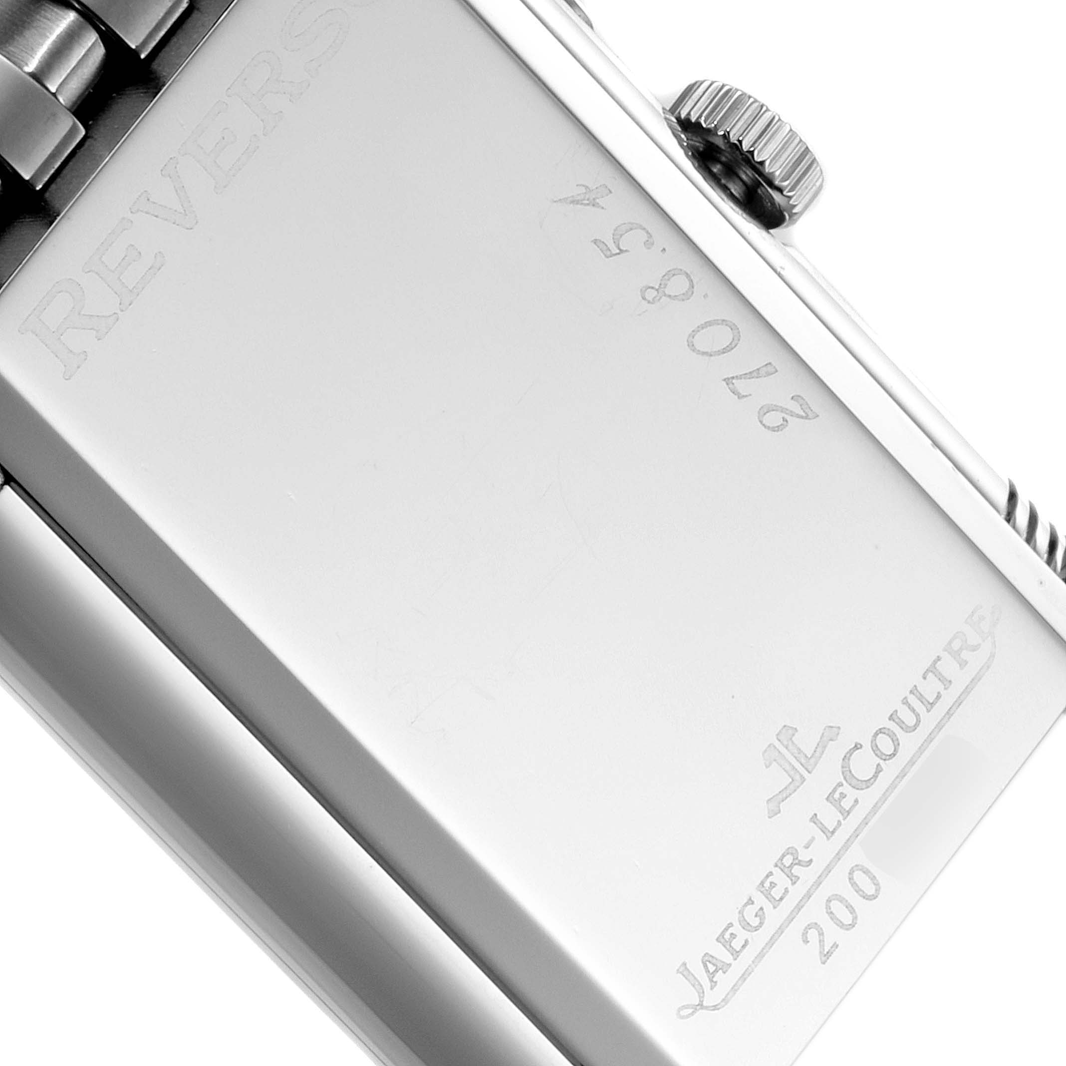 This image shows a close-up of the back case, crown, and part of the strap hinge of the Jaeger-LeCoultre Reverso watch.