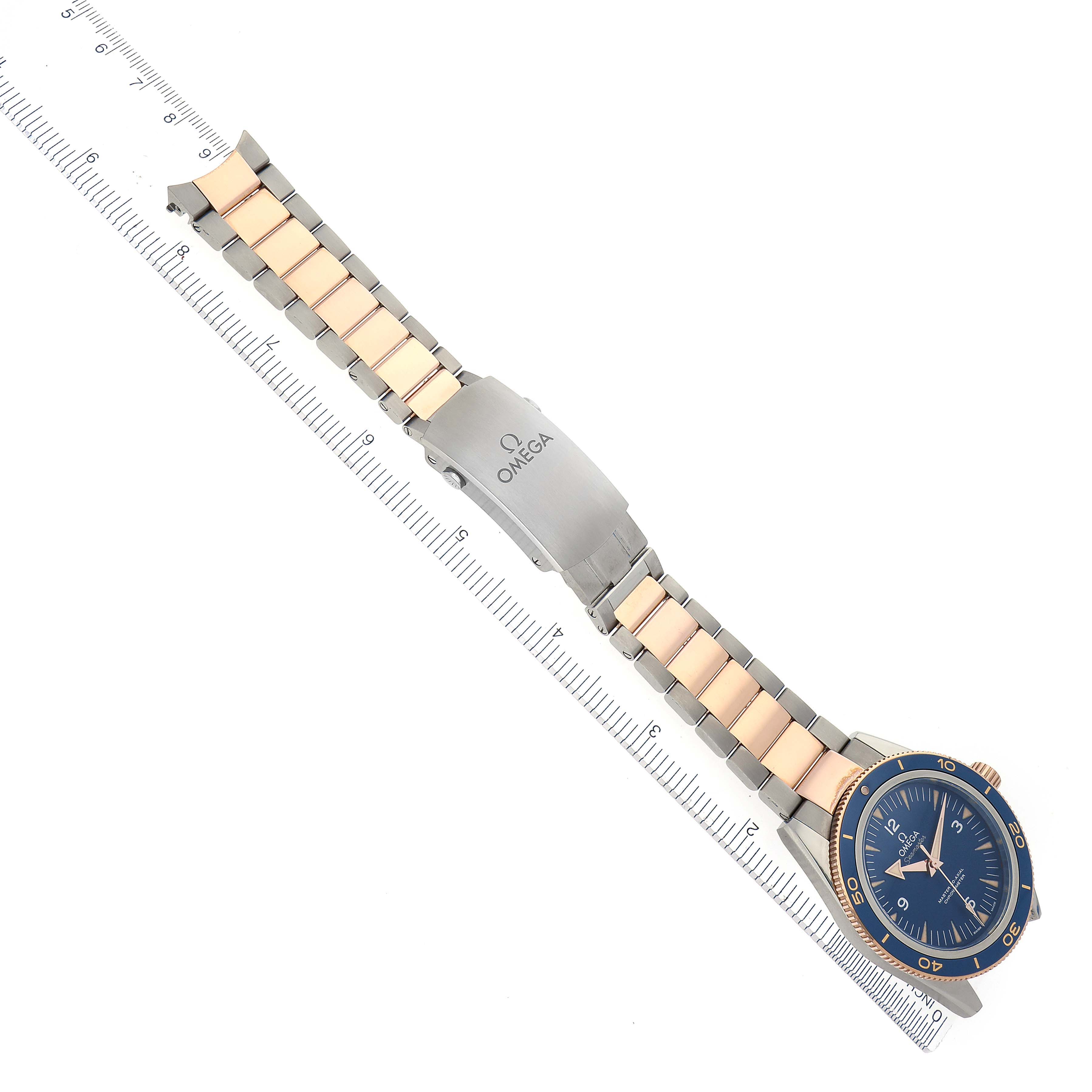 The Omega Seamaster 233.60.41.21.03.001 Men's Steel and Gold (two tone) Blue Dial 233.60.41.21.03.001 Men's Steel and Gold (two tone) Blue Dial watch is shown from an overhead angle, displaying its blue dial and metal bracelet with a folding clasp.