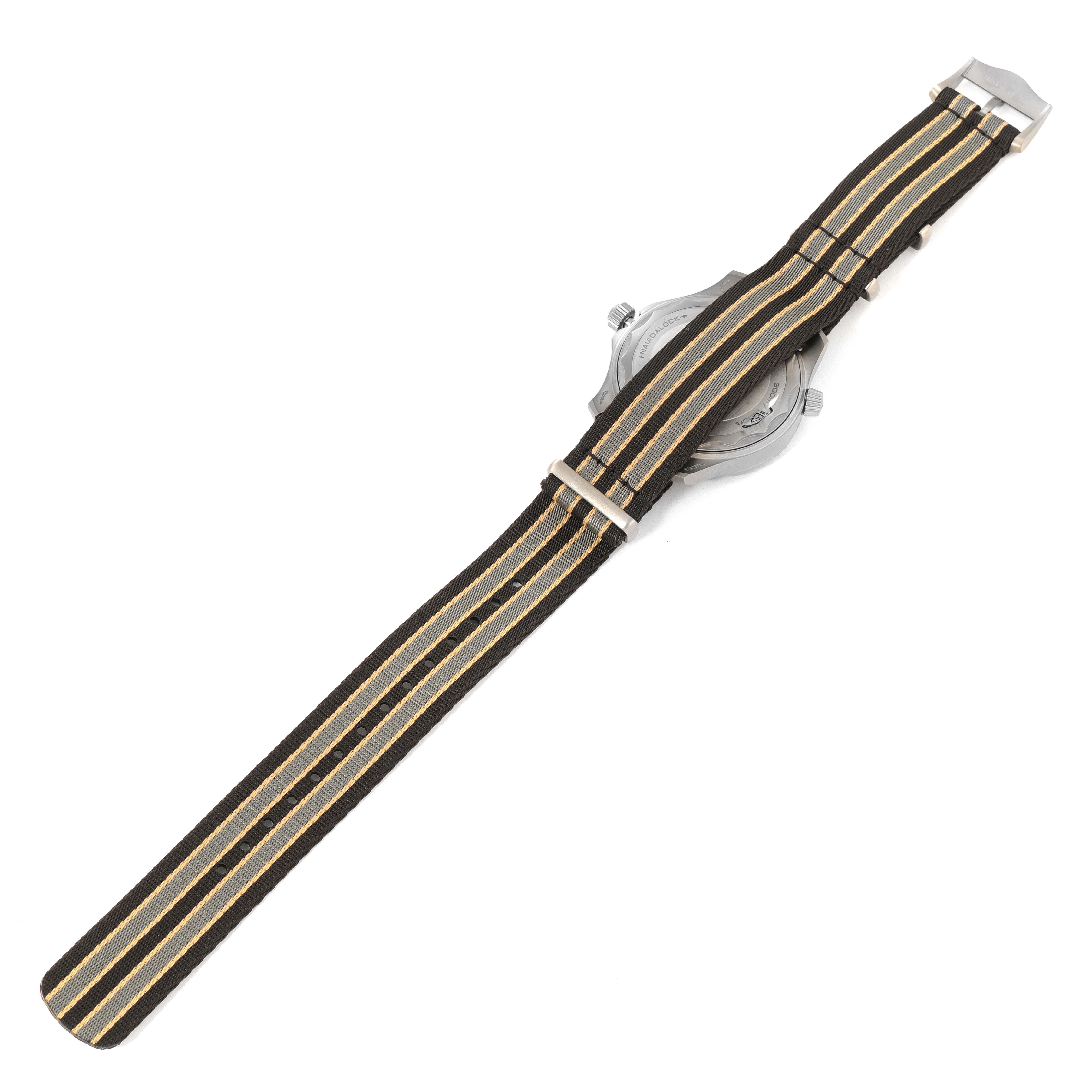 The image shows the back view of an Omega Seamaster 210.92.42.20.01.001 Men's Titanium Brown Dial 210.92.42.20.01.001 Men's Titanium Brown Dial watch, featuring a striped nylon strap and the watch case partially visible.