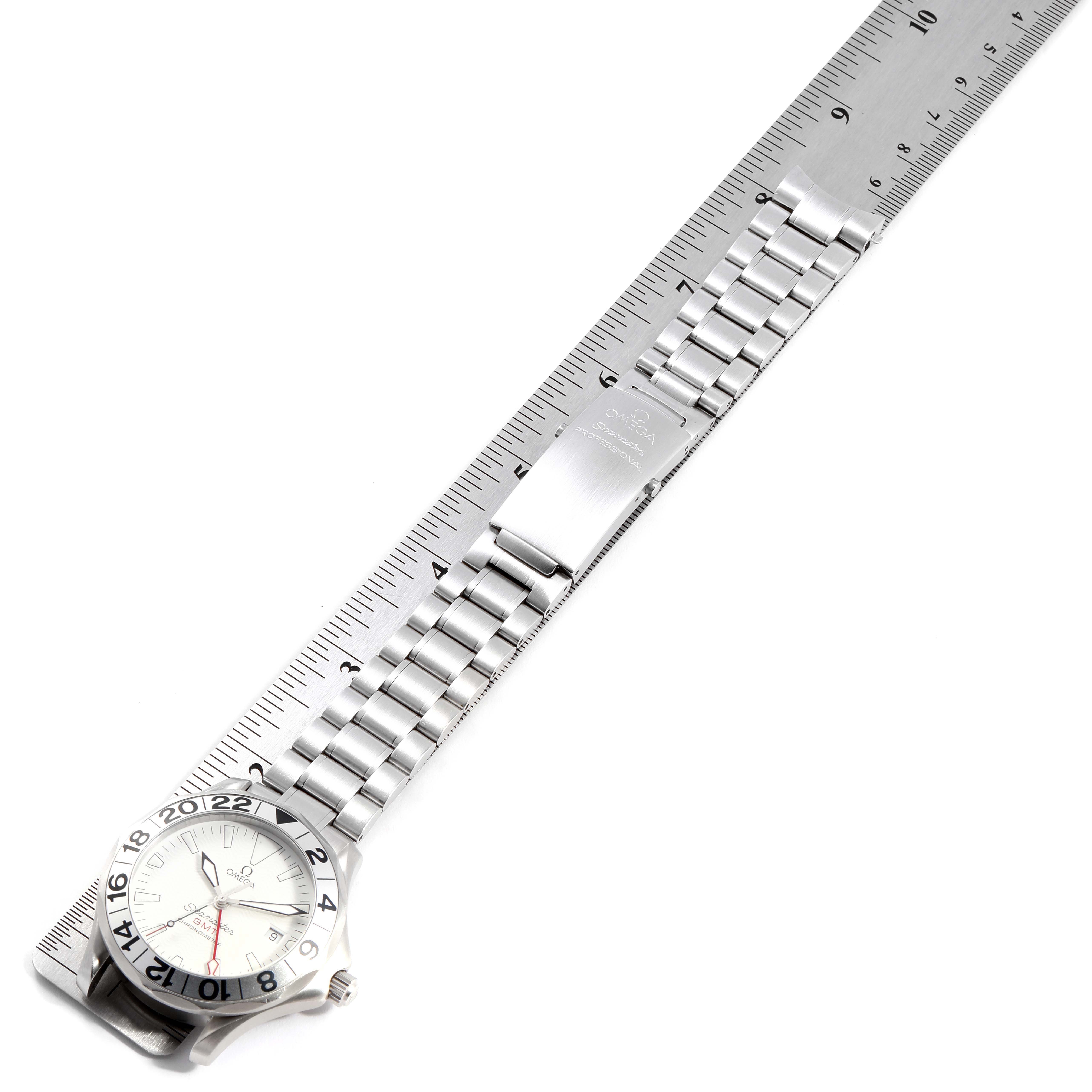 This image shows the Omega Seamaster 2538.20.00 Men's Stainless Steel White Dial 2538.20.00 Men's Stainless Steel White Dial watch laid flat with its stainless steel bracelet extended alongside a ruler.