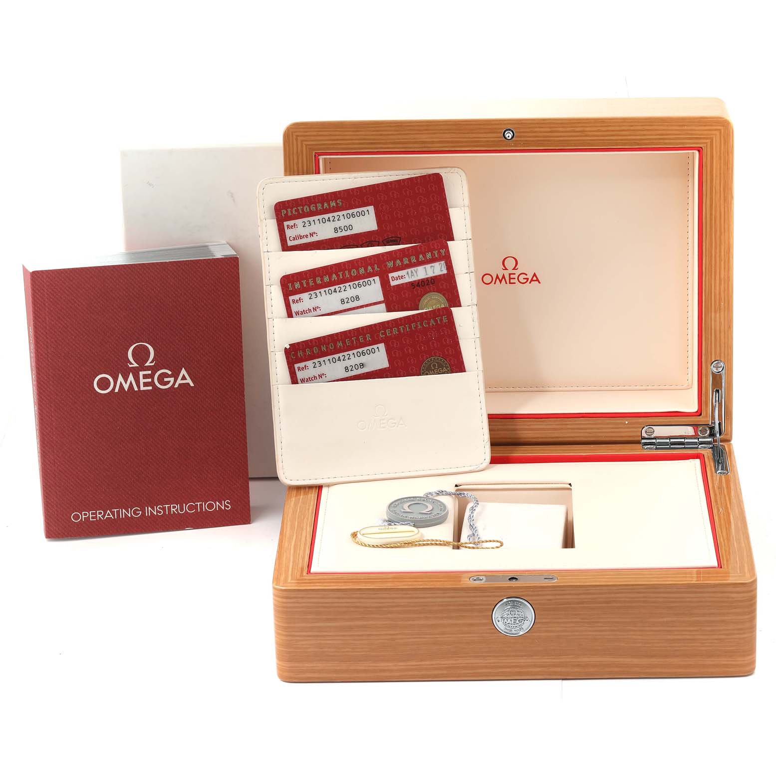 The image shows an Omega Aqua Terra 231.10.42.21.06.001 Men's Stainless Steel Grey Dial 231.10.42.21.06.001 Men's Stainless Steel Grey Dial watch accessory set including the box, cards, operating instructions, and medallion.