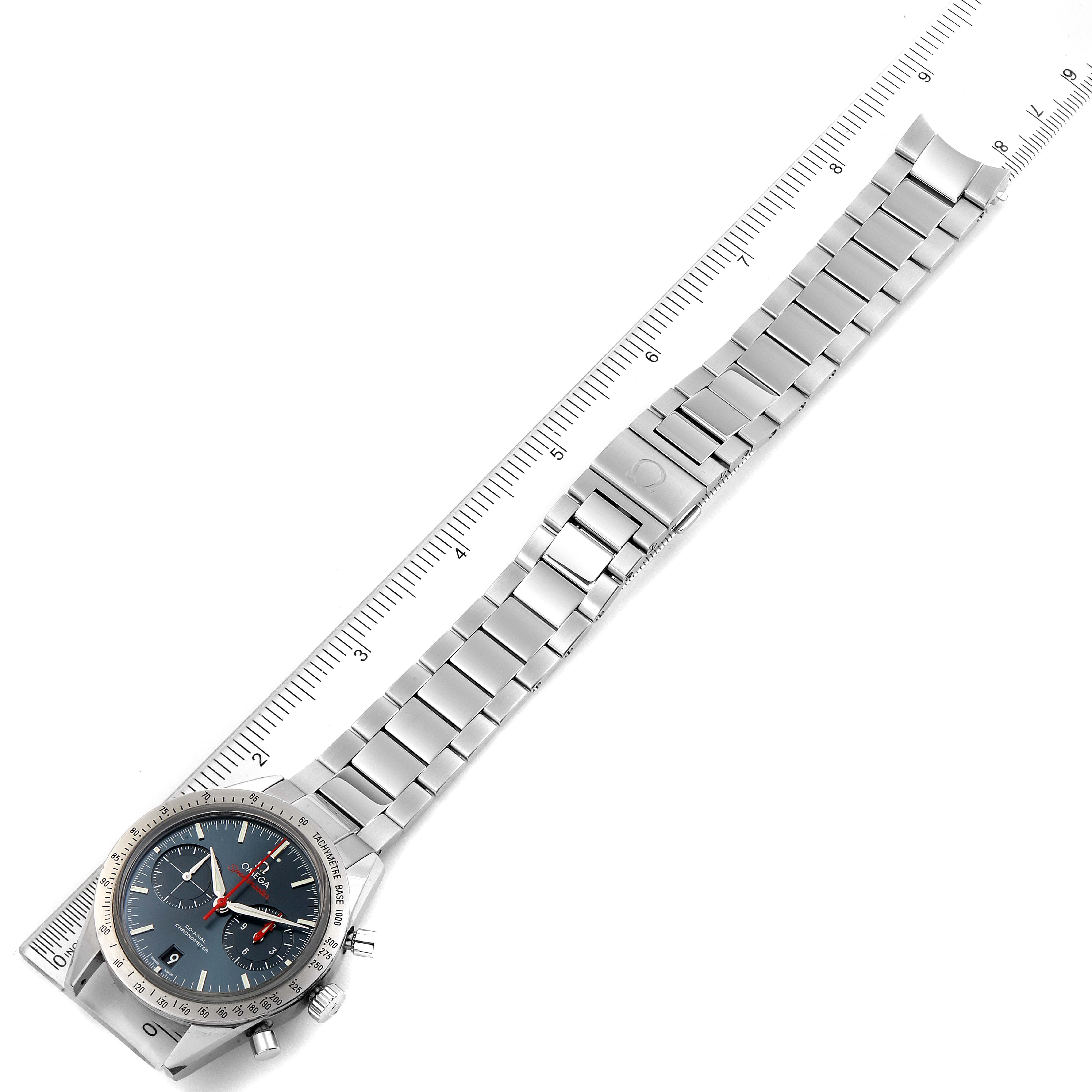 The Omega Speedmaster 331.10.42.51.03.001 Men
s Stainless Steel Blue Dial 331.10.42.51.03.001 Men
s Stainless Steel Blue Dial watch is shown from an angled top-down view, displaying the entire bracelet and face next to a ruler for scale.