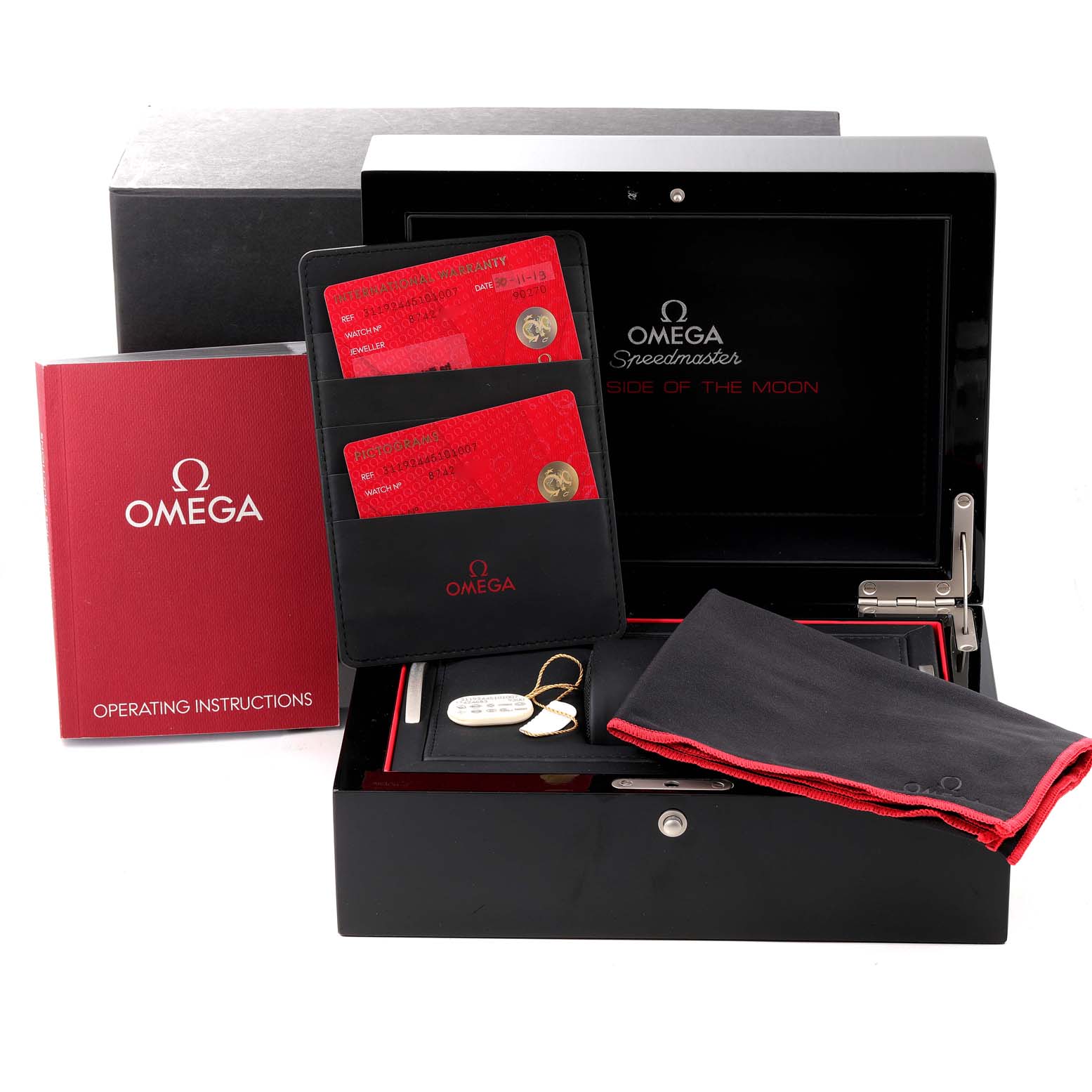 The image shows an Omega Speedmaster 311.92.44.51.01.007 Men's Ceramic Black Dial 311.92.44.51.01.007 Men's Ceramic Black Dial watch box, warranty cards, operating instructions, a cloth, and a keychain.