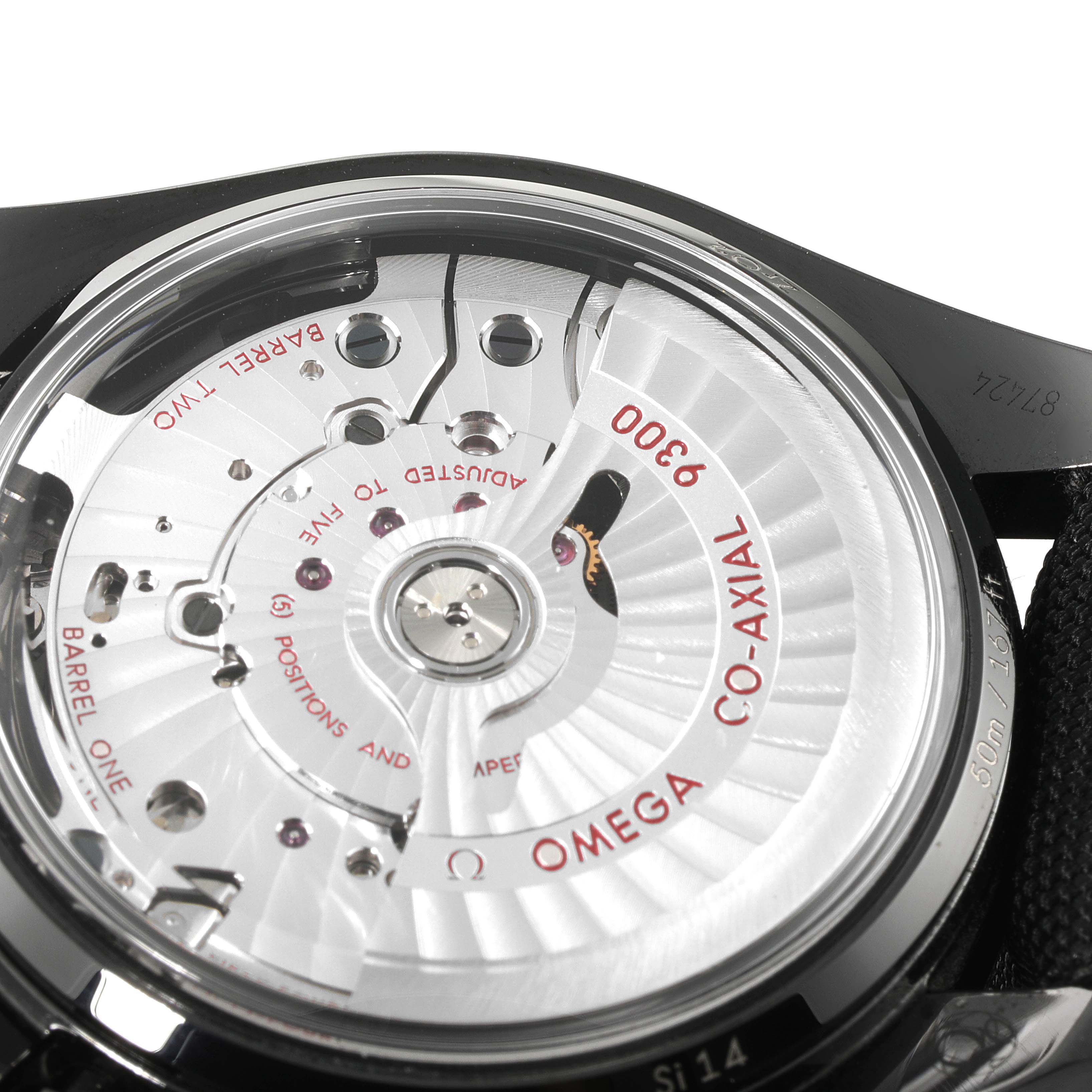 The image shows a close-up of the backside of an Omega Speedmaster 311.92.44.51.01.007 Men's Ceramic Black Dial 311.92.44.51.01.007 Men's Ceramic Black Dial watch, focusing on the Co-Axial 9300 movement.