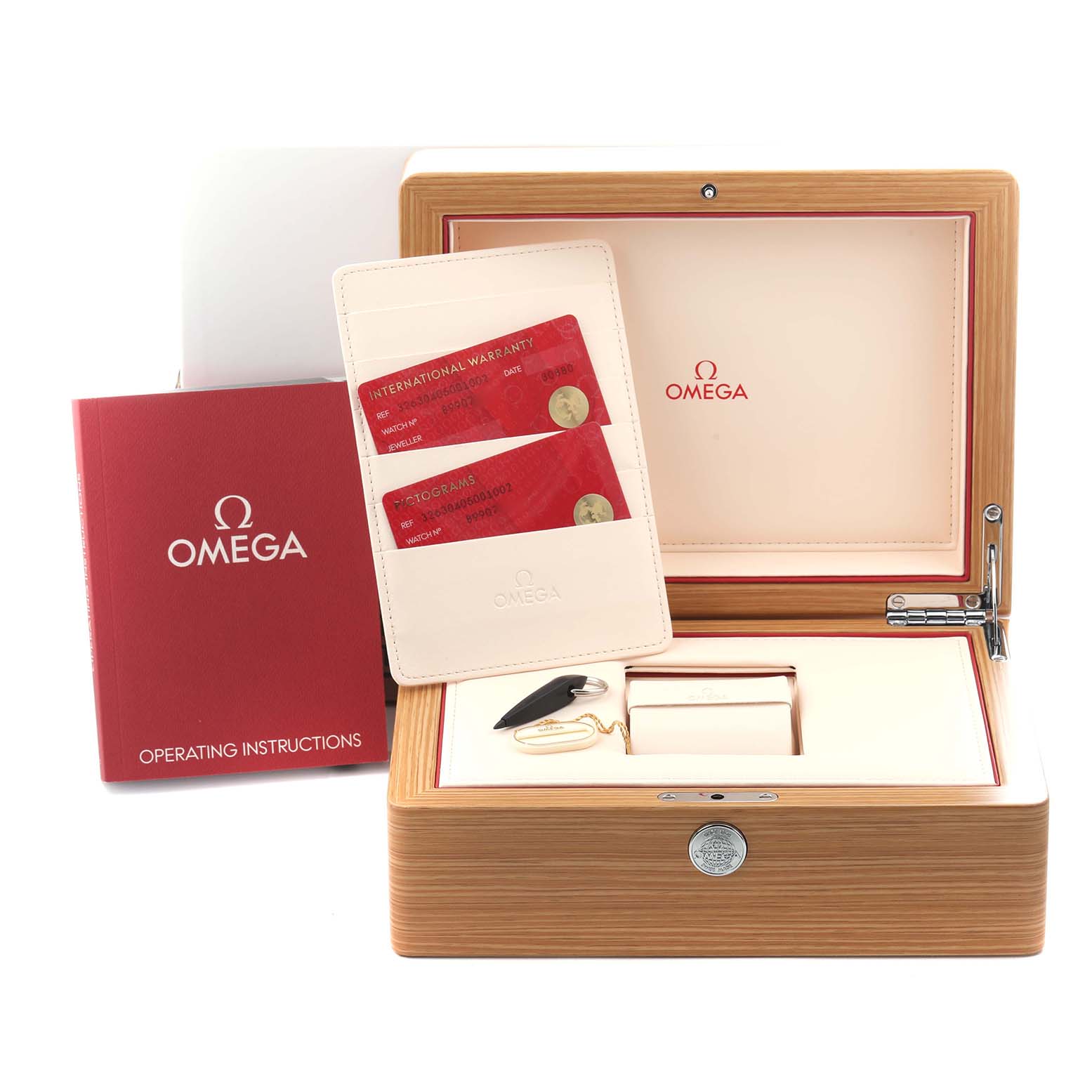 The image shows an Omega Speedmaster 326.30.40.50.01.002 Men's Stainless Steel Black Dial 326.30.40.50.01.002 Men's Stainless Steel Black Dial watch box with warranty cards, a booklet, and a key, viewed from the front.