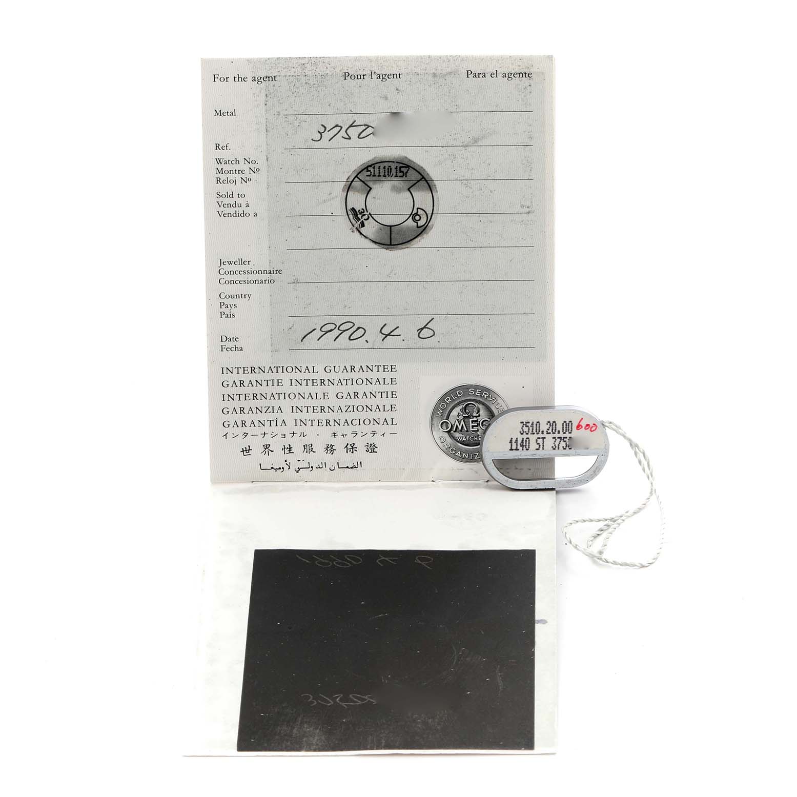 The image shows the international guarantee card and tags for an Omega Speedmaster 3510.20.00 Men's Stainless Steel White Dial 3510.20.00 Men's Stainless Steel White Dial watch.