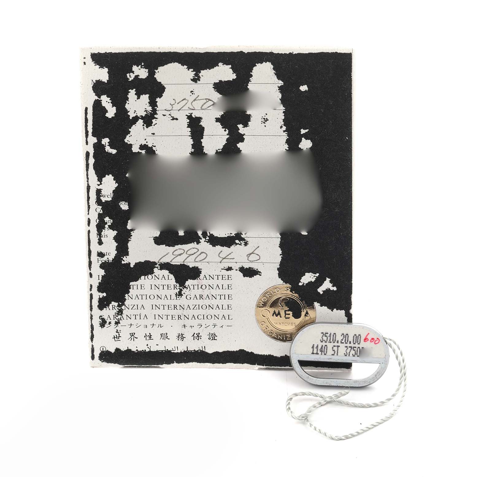 The image shows an Omega Speedmaster 3510.20.00 Men's Stainless Steel White Dial 3510.20.00 Men's Stainless Steel White Dial international guarantee card and a metal tag with model numbers.