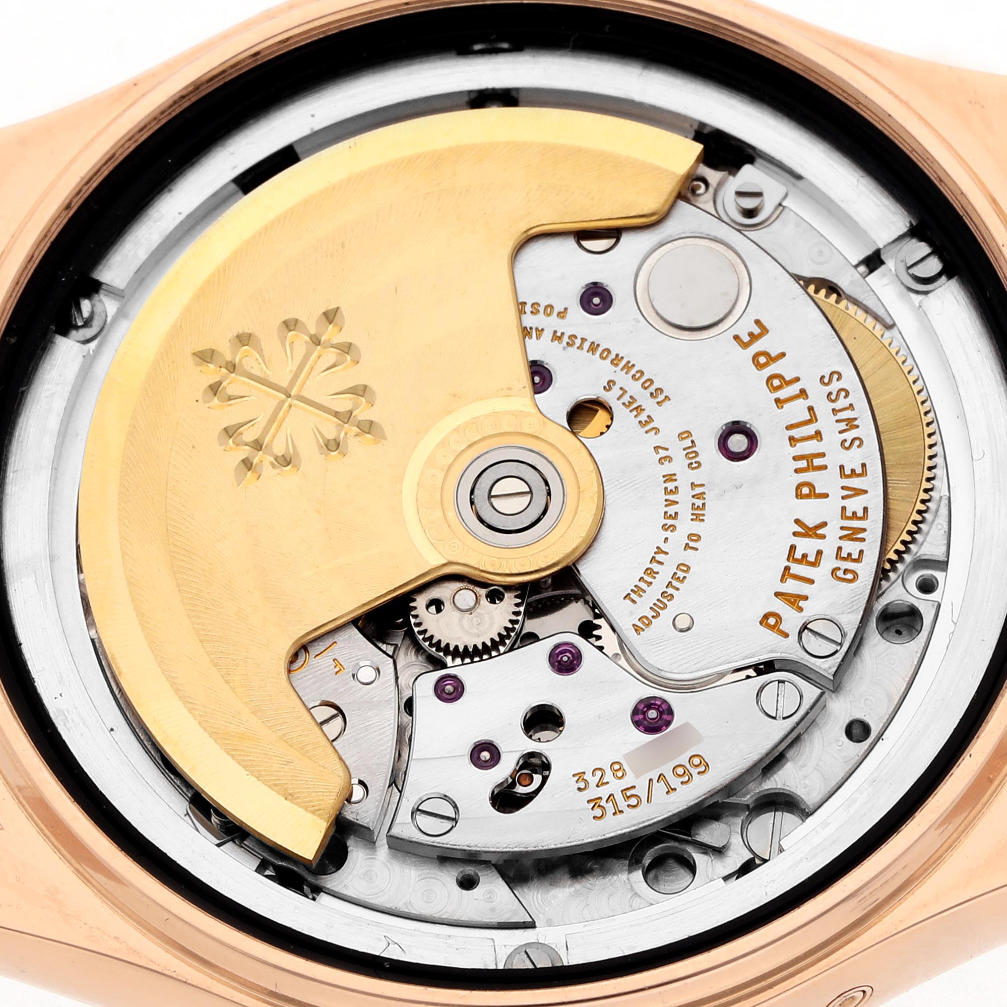 The image shows the movement of a Patek Philippe Complications 5036/1R Men's Rose Gold White Dial 5036/1R Men's Rose Gold White Dial watch from the back, highlighting the rotor and intricate internal mechanisms.