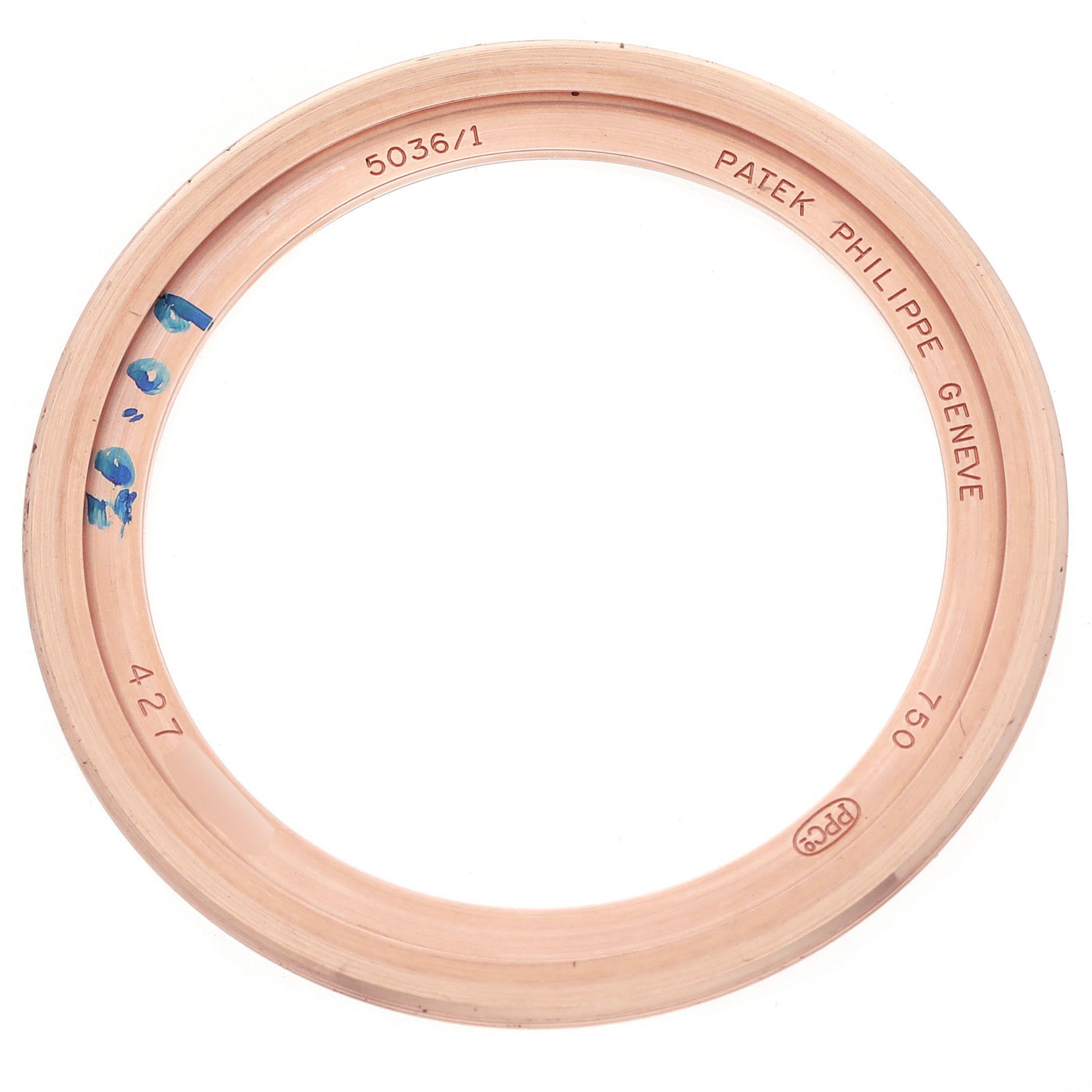 The image shows the bezel of a Patek Philippe Complications 5036/1R Men's Rose Gold White Dial 5036/1R Men's Rose Gold White Dial watch, featuring markings and engravings on the inside.