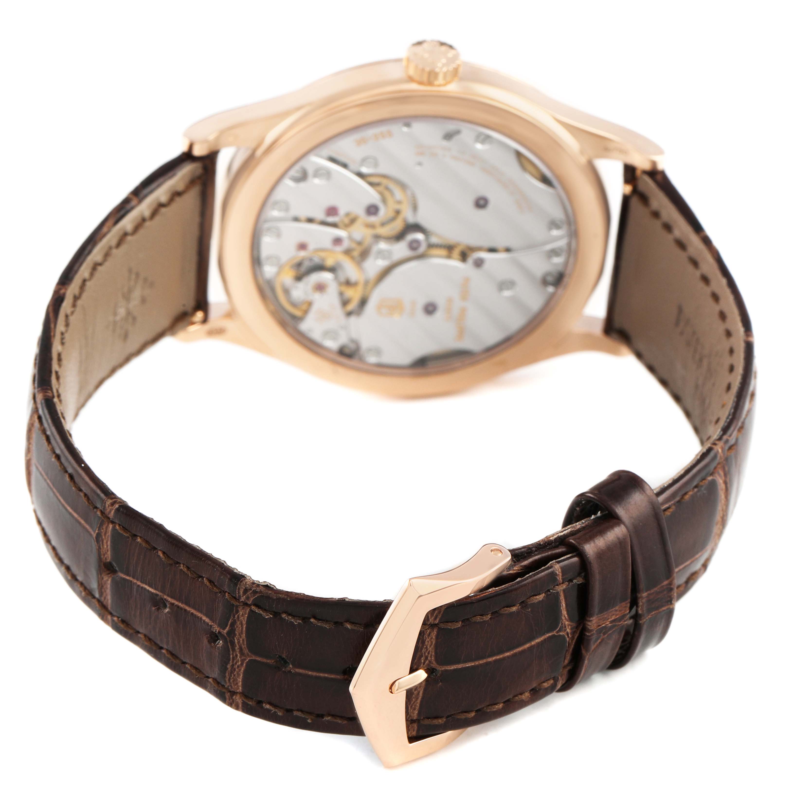 The image shows the back view of a Patek Philippe Calatrava 6119 6119R Men's Rose Gold Silver Dial watch, highlighting its movements and leather strap with a clasp.