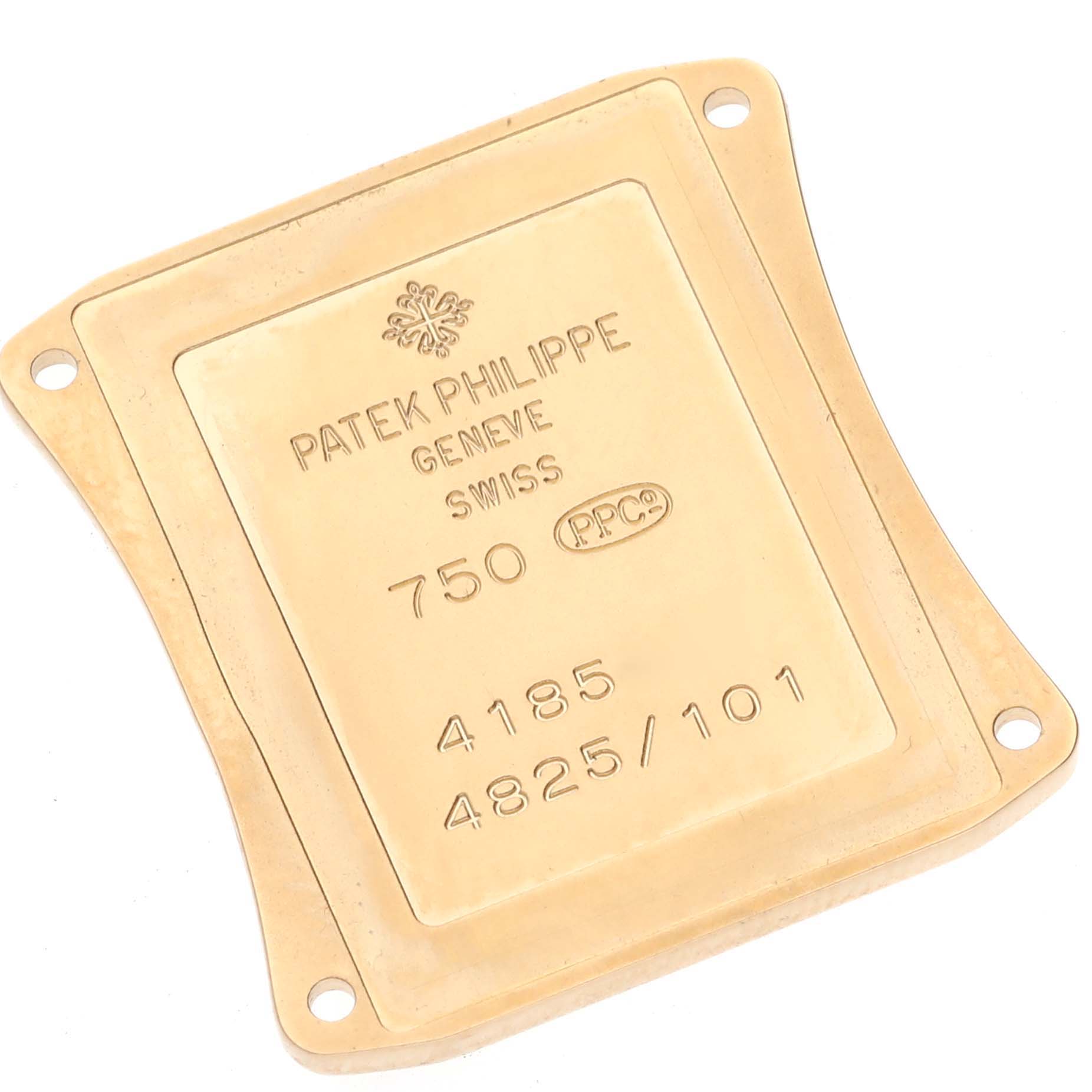 The image shows the gold back plate of a Patek Philippe Gondolo 4825/101J-001 Women's Yellow Gold Mother of Pearl Dial 4825/101J-001 Women's Yellow Gold Mother of Pearl Dial watch from a top-down angle.