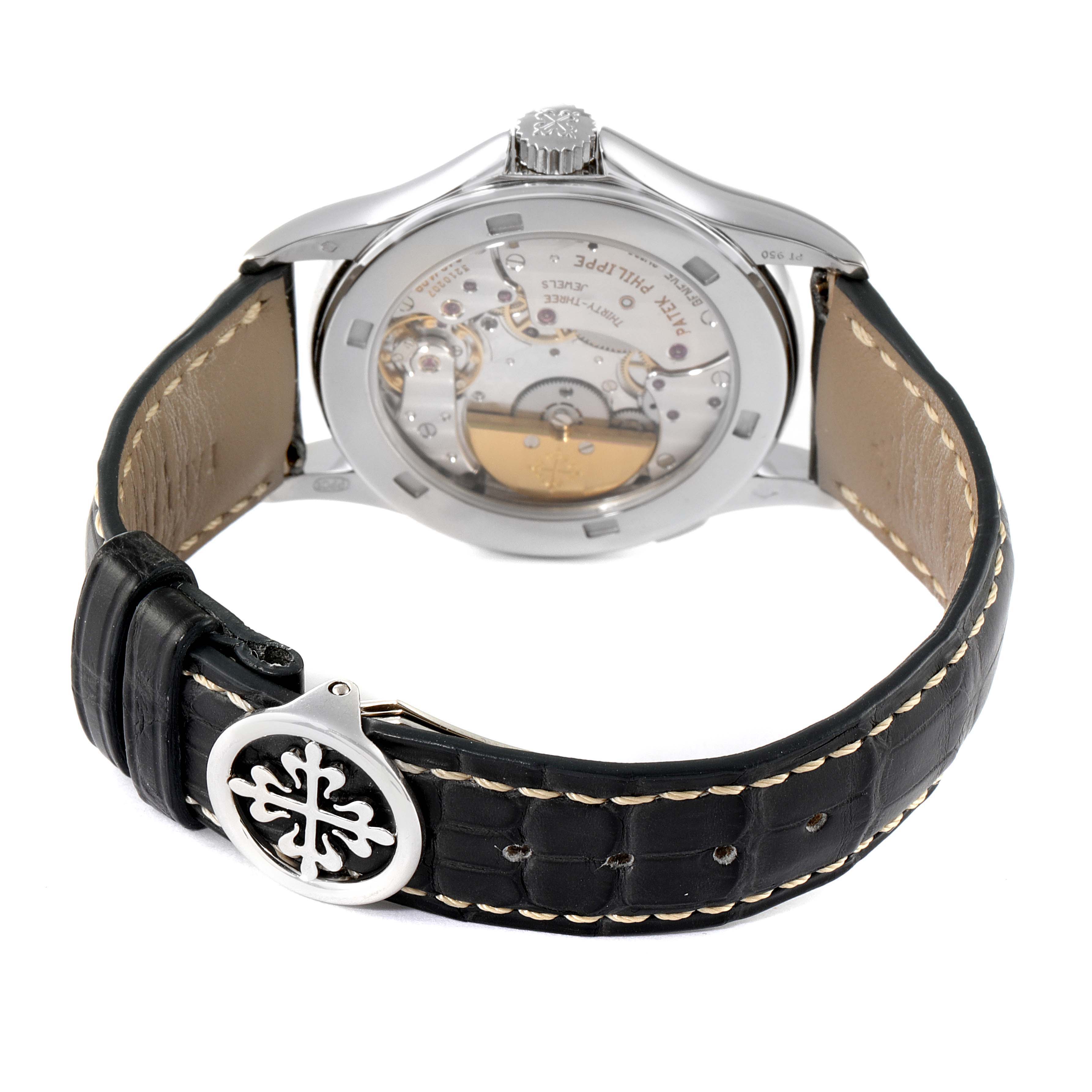 This image shows the back of a Patek Philippe Complications 5110P-001 Men's Platinum Silver Dial 5110P-001 Men's Platinum Silver Dial model watch, highlighting the open caseback and black leather strap with a clasp.